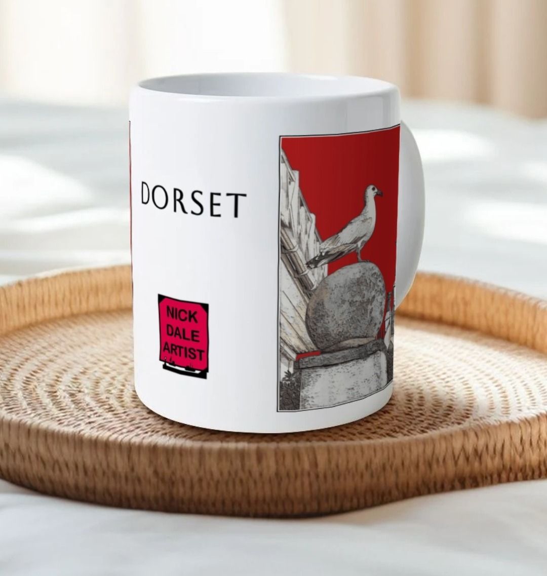 Image of a White Mug on a tray on a bed featuring a modified copy of the painting 'A View Of The Sea At Lyme Regis' by Nick Dale - this being the 'Red' version. Image also shows the artist's logo on the mug with the word 'Dorset' written above it. The mug handle is obscured behind the mug. The mug depicts a gull and buildings along Marine Parade, Lyme Regis.