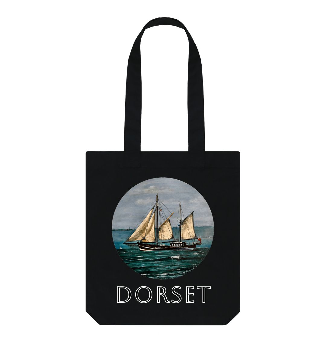 Image of a Black Tote Bag featuring a copy of the painting 'Moonfleet Sailing Past Portland' by Nick Dale, with the word 'Dorset' written beneath it. The bag depicts the tall ship Moonfleet sailing past the western coast of Portland, Dorset. As observed from Ringstead Beach.