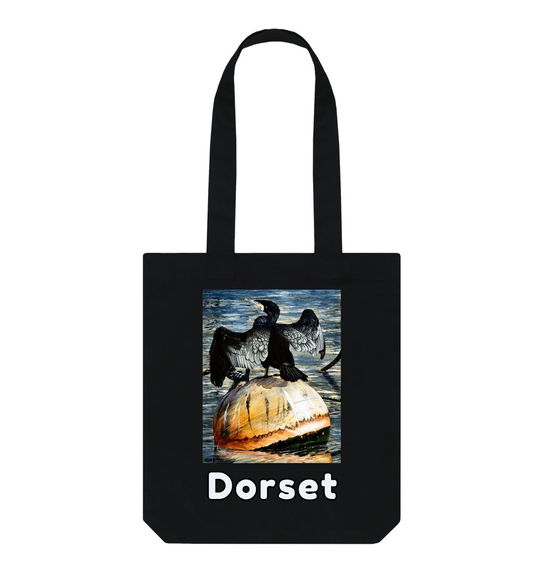 Image of a Black Tote Bag featuring a copy of the painting 'Cormorant At West Bay' by Nick Dale. The bag depicts a close-up of a cormorant sunbathing on a mooring buoy in West Bay's harbour in Dorset.