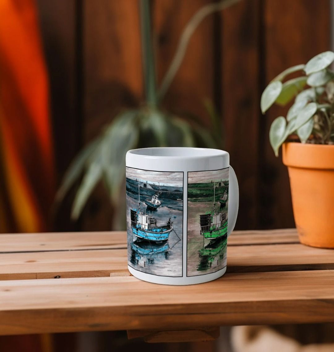 Image of a White Mug on a wooden shelf featuring multiple modified copies of the painting 'Lyme Regis at Low Tide' by Nick Dale. The mug handle is obscured behind the mug. The mug depicts 3 versions of a sunset scene where the fishing vessels rest on the floor of Lyme Regis harbour whilst the tourists enjoy the view from the Cobb. Each of the 3 versions is tinted a different colour; being red, blue and green.