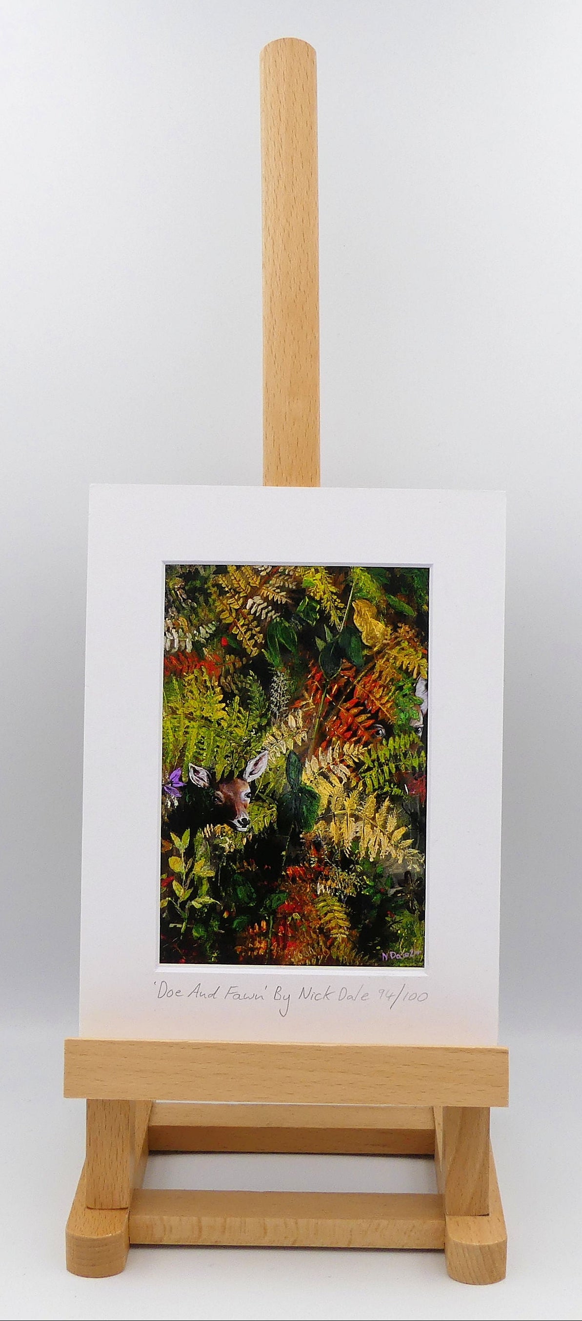 Image of a Small Art Print featuring a copy of the painting 'Doe And Fawn' by Nick Dale. The print depicts a Row Deer doe and fawn hiding in the dense undergrowth with only their heads visible. The print is situated on a small easel.