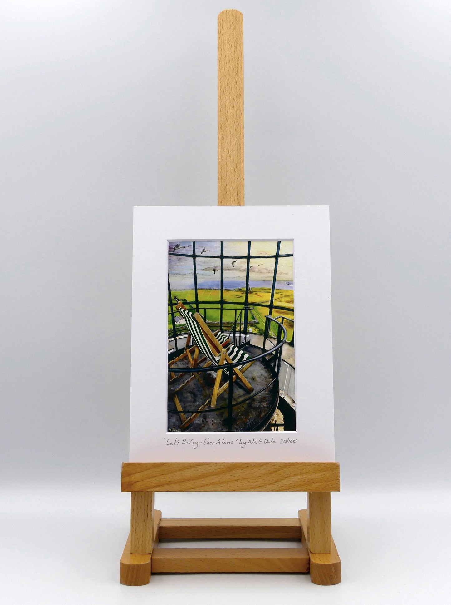 Image of a Small Art Print featuring a copy of the painting 'Let's Be Together Alone' by Nick Dale. The print depicts the view from the lantern room of the Old Light lighthouse on Beacon Hill, on the island of Lundy, Devon. The print is situated on a small easel.