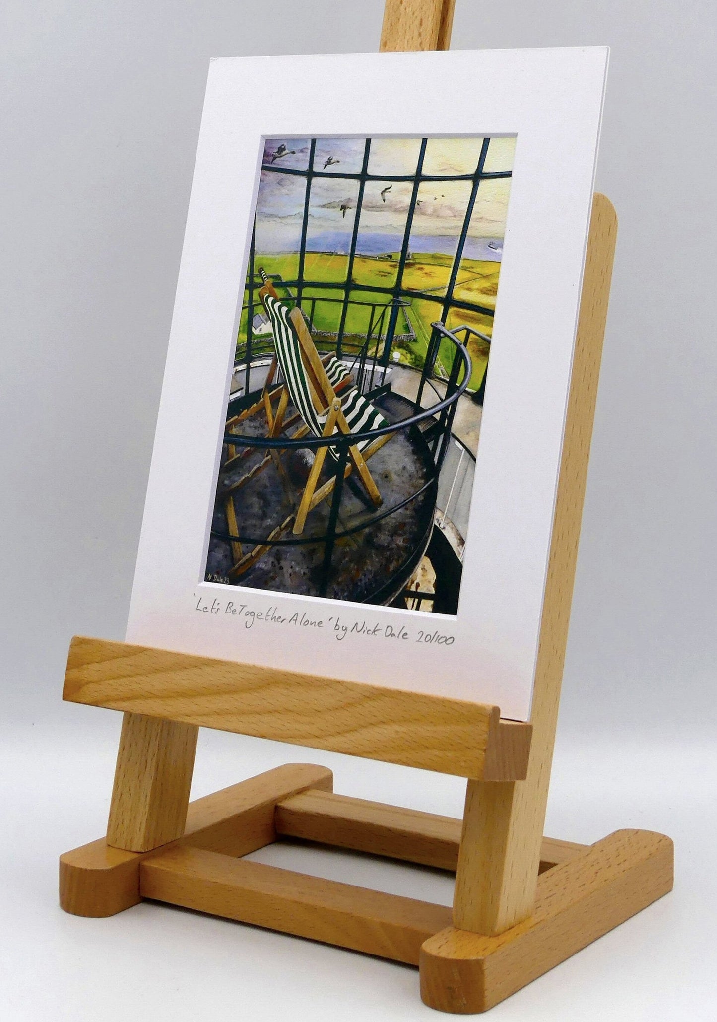 Image of a Small Art Print featuring a copy of the painting 'Let's Be Together Alone' by Nick Dale. The print depicts the view from the lantern room of the Old Light lighthouse on Beacon Hill, on the island of Lundy, Devon. The print is situated on a small easel.