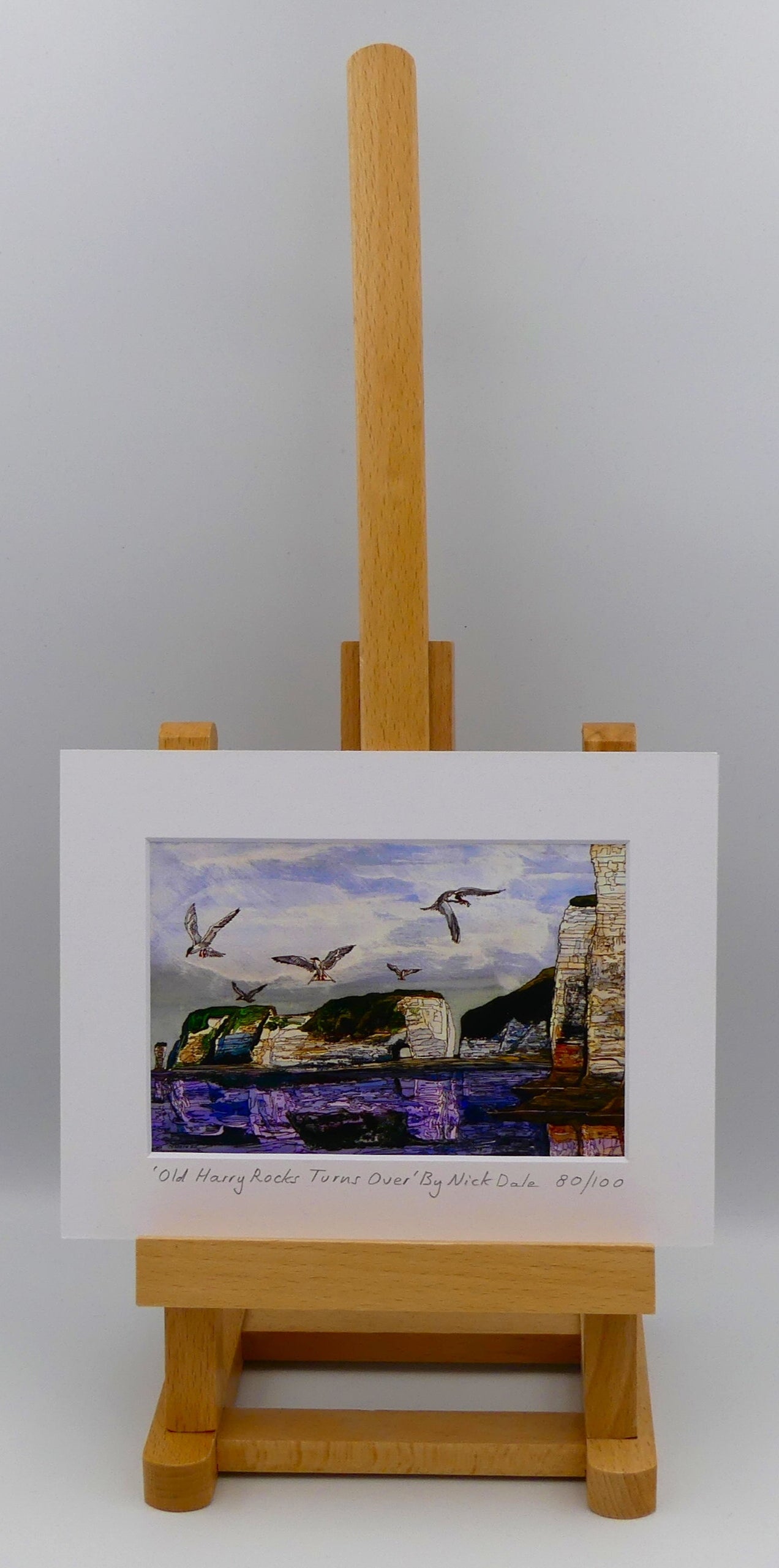 Image of a Small Art Print featuring a copy of the painting 'Old Harry Rocks Turns Over' by Nick Dale. The print depicts the view on a walk in March 2025 when the tide was completely out so I could walk to Old Harry Rocks. I never realised that that was ever possible. I had to add in the water when I painted it afterwards as it was completely missing. Turns also added to taste. The print is situated on a small easel.