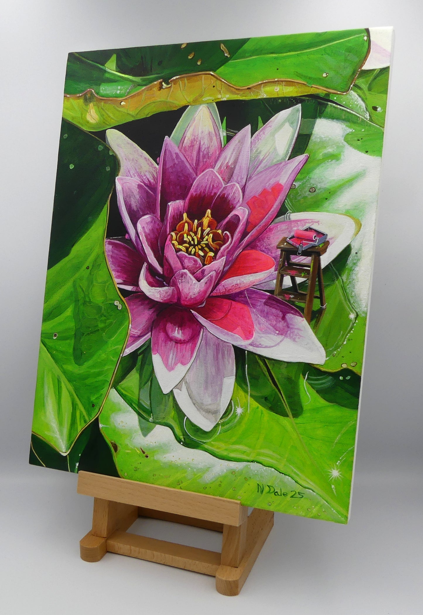 Image of the original painting 'Painting The Lily' by Nick Dale on a small easel. The scene depicts a close up view of a water lily as observed at Bennetts Water Gardens in Weymouth; albeit with the added extra of some painting equipment. The title is a reference to William Shakespeare's play 'King John'.