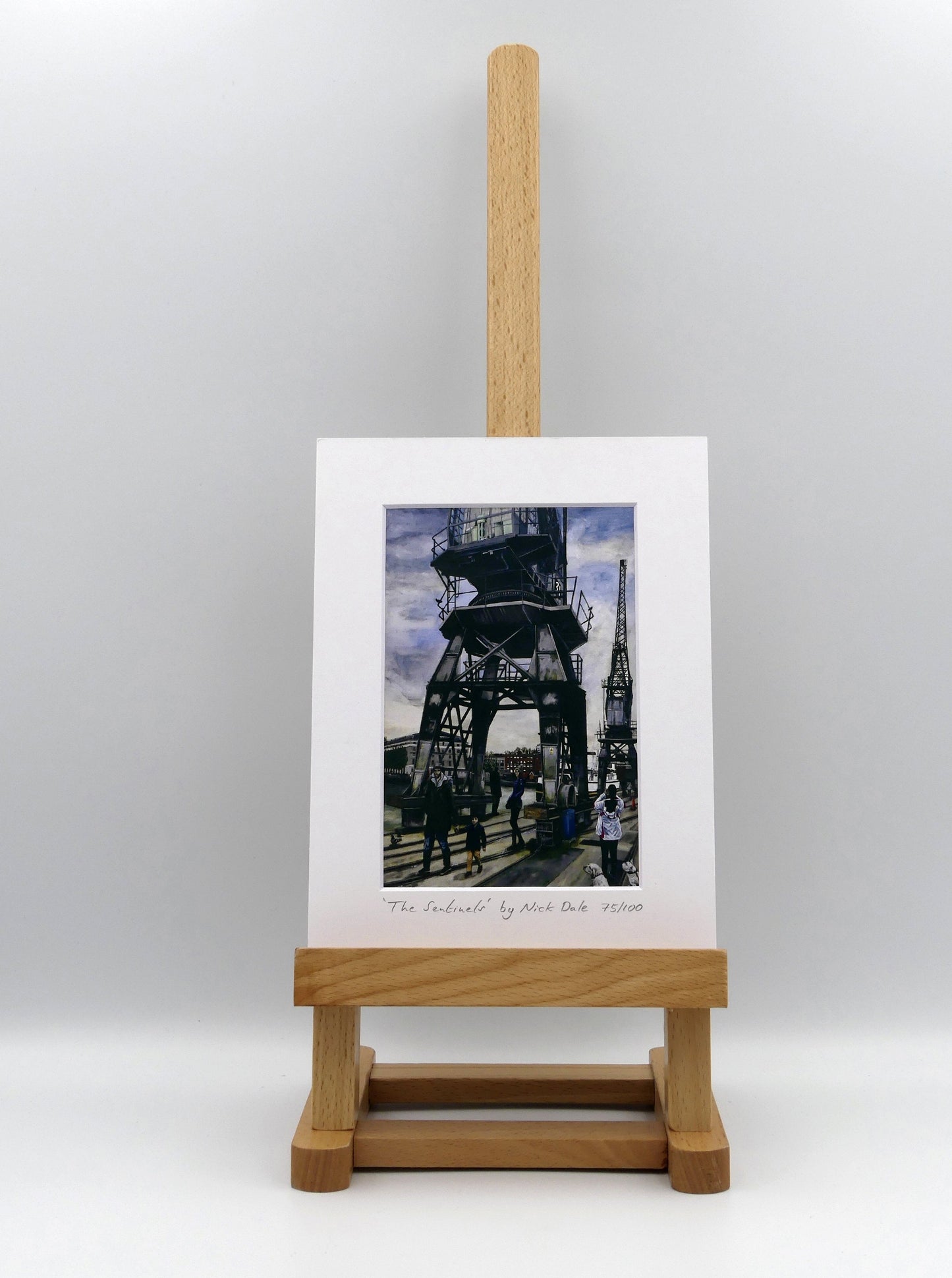 Image of a Small Art Print featuring a copy of the painting 'The Sentinels' by Nick Dale. The print depicts the iconic tower cranes of Bristol Docks and the classic ship MV Balmoral beyond them. The print is situated on a small easel.