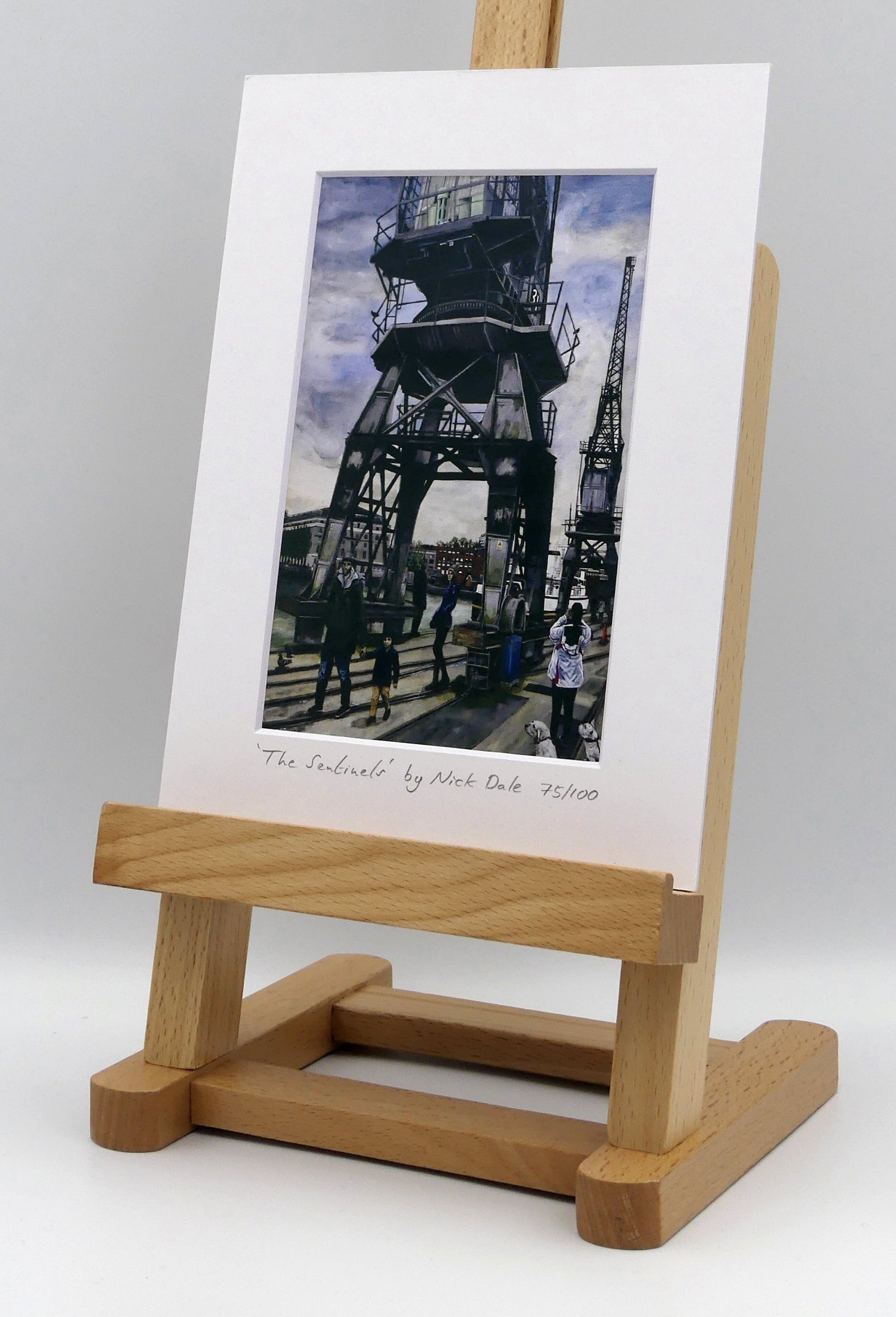 Image of a Small Art Print featuring a copy of the painting 'The Sentinels' by Nick Dale. The print depicts the iconic tower cranes of Bristol Docks and the classic ship MV Balmoral beyond them. The print is situated on a small easel.
