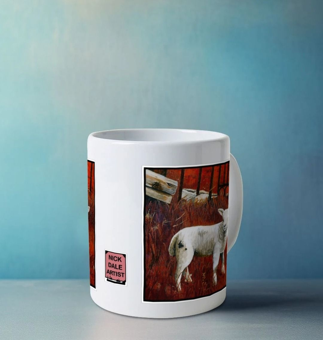 Image of a White Mug on a white worksurface featuring a modified copy of a detail from the painting 'The Gate' by Nick Dale. Image also shows artist's logo on the mug. The mug handle is obscured behind the mug. The mug depicts a lamb in front of an ornamental garden gate reused by a farmer somewhere in North Devon, probably to the south of Valley of Rocks, Lynton. The lamb was observed on Lundy Island, Devon.
