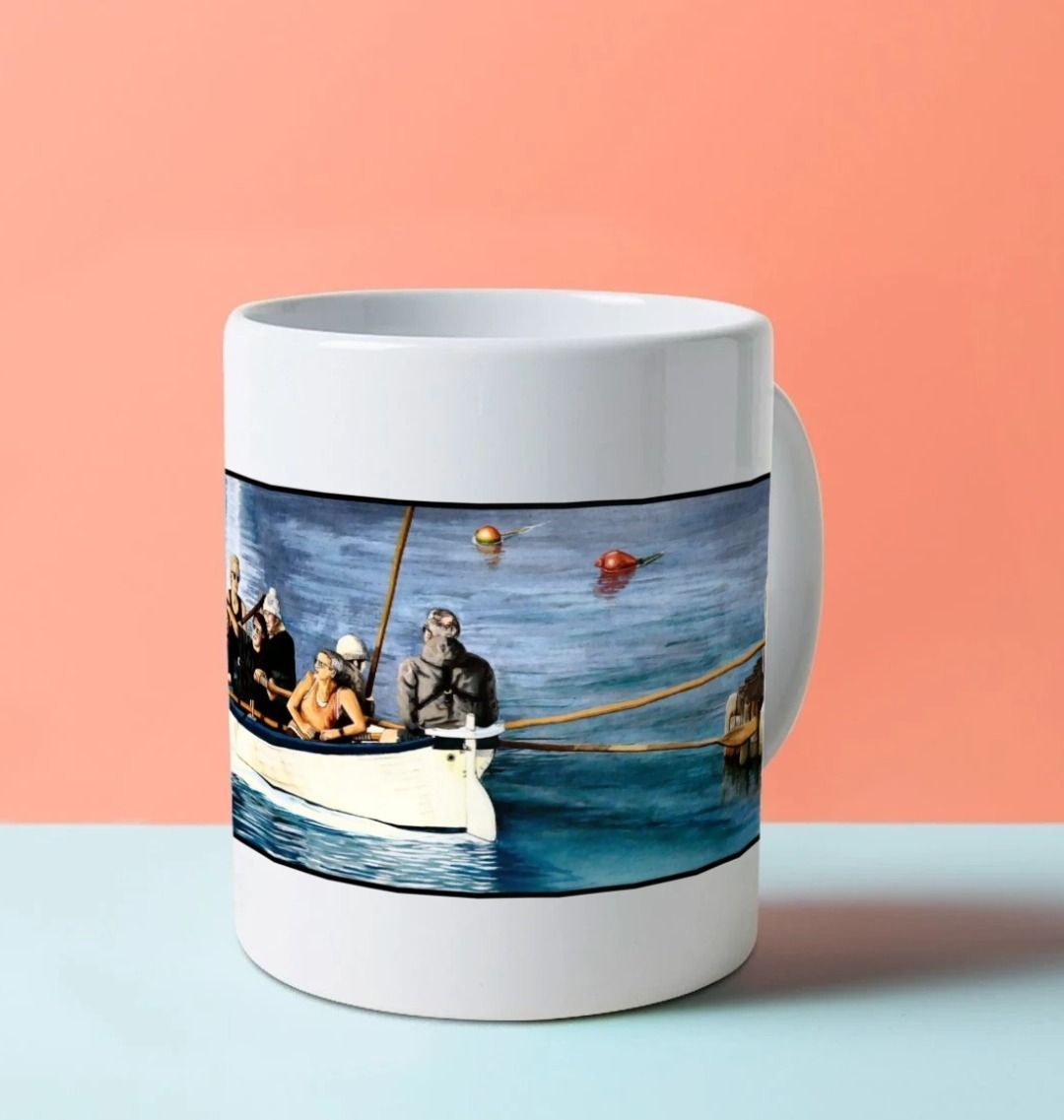 Image of a White Mug on a blue worksurface featuring a copy of the painting 'The Return to Base at Lyme Regis' by Nick Dale. The mug handle is obscured behind the mug. The mug depicts the crew of a gig rowing boat returning to Lyme Regis Harbour to take a well-earned rest.