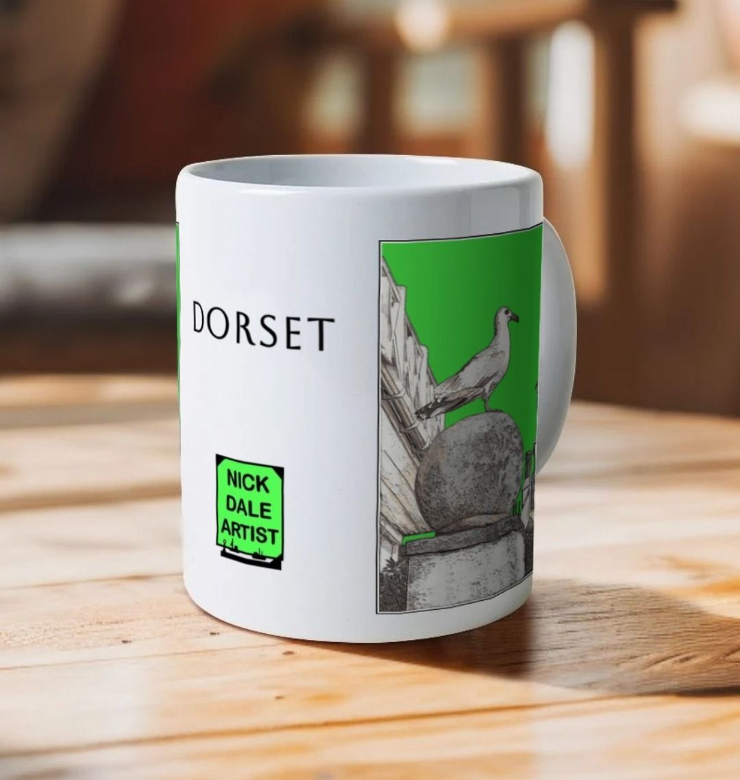 Image of a White Mug on a wooden table featuring a modified copy of the painting 'A View Of The Sea At Lyme Regis' by Nick Dale - this being the 'Green' version. Image also shows the artist's logo on the mug with the word 'Dorset' written above it. The mug handle is obscured behind the mug. The mug depicts a gull and buildings along Marine Parade, Lyme Regis.