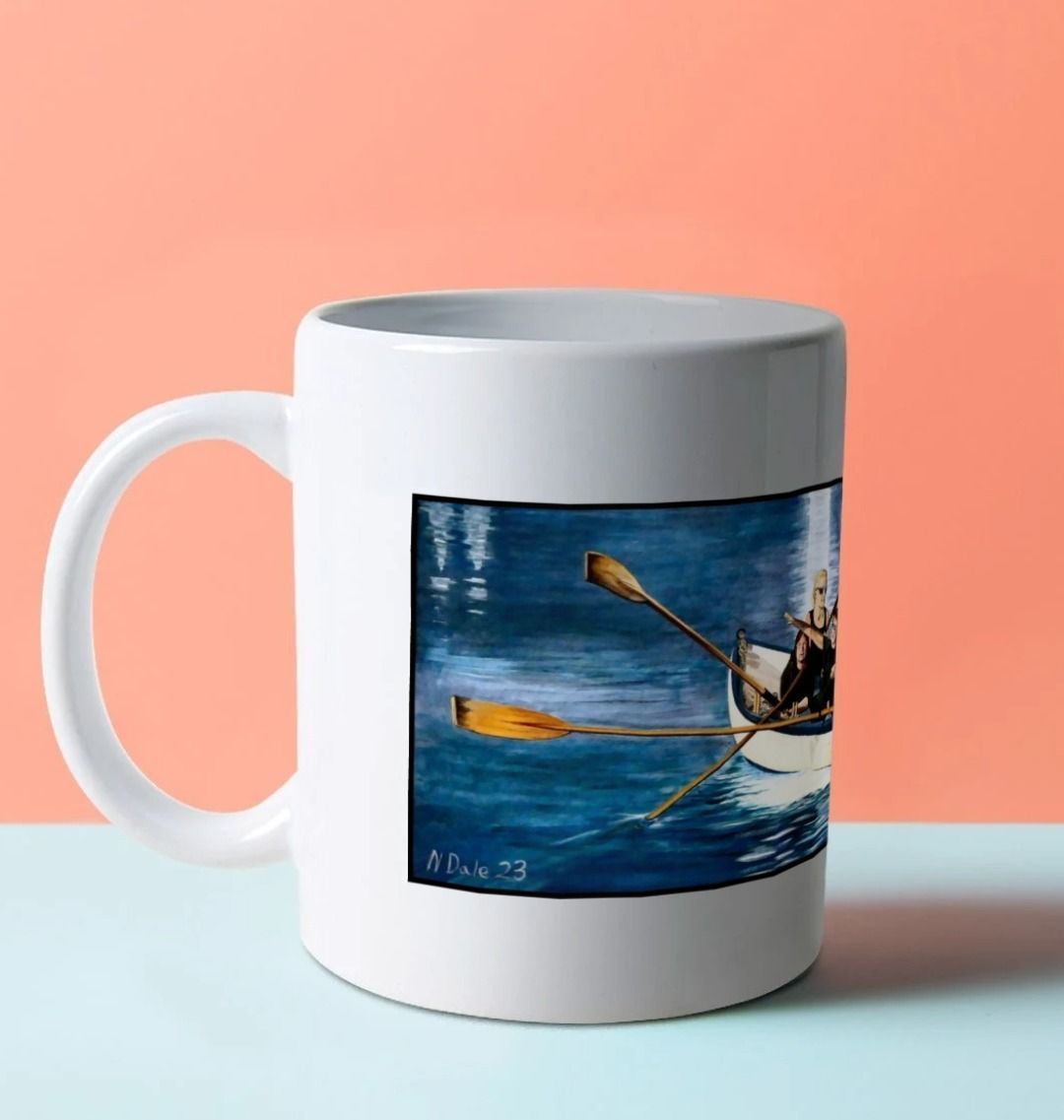 Image of a White Mug on a blue worksurface featuring a copy of the painting 'The Return to Base at Lyme Regis' by Nick Dale. The handle is orientated to the left. The mug depicts the crew of a gig rowing boat returning to Lyme Regis Harbour to take a well-earned rest.