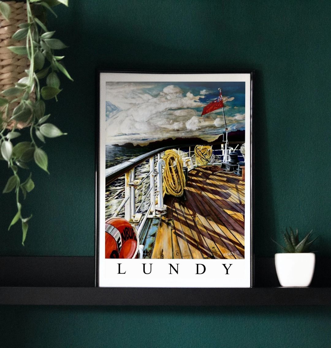 Image of a Large Art Print (A3 size) featuring a copy of the painting 'Diminishing Returns From Lundy' by Nick Dale, with the word 'Lundy' written beneath it. As displayed in a frame on a shelf. The print depicts the stern of the ship MS Oldenburg as it returns to the mainland from Lundy Island, Devon. As the sun goes down it casts long shadows on the deck. whilst the flag flutters in the breeze. The Silhouette of the island can be seen diminishing into the background.
