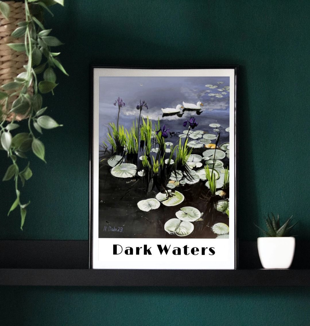 Image of a Large Art Print (A3 size) featuring a copy of the painting 'Dark Waters' by Nick Dale, with the words 'Dark Waters' written beneath it. As displayed in a frame on a shelf. The print depicts lily pads, irises and ducks on a pond at Knightshayes Court, Devon.