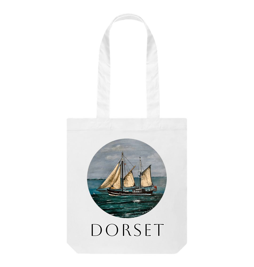 Image of a White Tote Bag featuring a copy of the painting 'Moonfleet Sailing Past Portland' by Nick Dale, with the word 'Dorset' written beneath it. The bag depicts the tall ship Moonfleet sailing past the western coast of Portland, Dorset. As observed from Ringstead Beach.