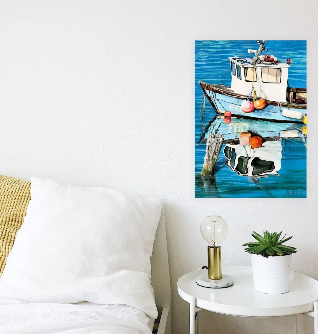 Image of a Large Art Print (A3 size) featuring a copy of the painting 'God's Own 99 Flake Pierces The Veil' by Nick Dale. As displayed on a wall next to a bed. The print depicts a fishing boat at rest within the harbour of Lyme Regis, Dorset. The title is based on the similarity of the wooden pile to a chocolate flake as inserted into an ice cream cone. This seemed appropriate given the draw of the town to tourists.