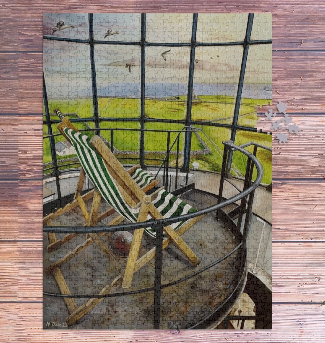 Image of a 1000 Piece Jigsaw Puzzle featuring a copy of the painting 'Let's Be Together Alone' by Nick Dale. As displayed partially completed on a wooden table. The jigsaw depicts the view from the lantern room of the Old Light lighthouse on Beacon Hill, on the island of Lundy, Devon.