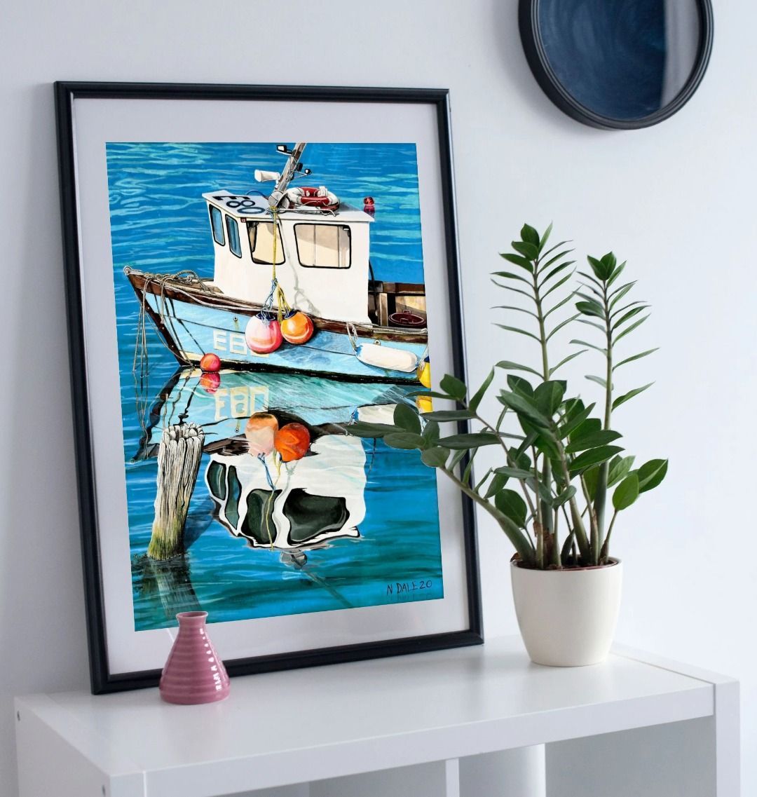 Image of a Large Art Print (A3 size) featuring a copy of the painting 'God's Own 99 Flake Pierces The Veil' by Nick Dale. As displayed in a frame on a shelf. The print depicts a fishing boat at rest within the harbour of Lyme Regis, Dorset. The title is based on the similarity of the wooden pile to a chocolate flake as inserted into an ice cream cone. This seemed appropriate given the draw of the town to tourists.