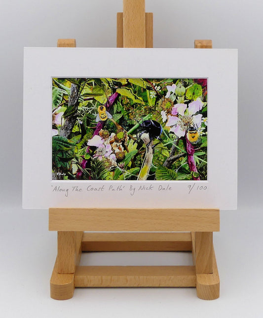 Image of a Small Art Print featuring a copy of the painting 'Along The Coast Path' by Nick Dale. The print depicts a close-up view of a coast path hedgerow on the Dorset/Devon border. A bloody-nosed beetle edges its way along a plant stem whilst bees attend the bramble flowers. The print is situated on a small easel.