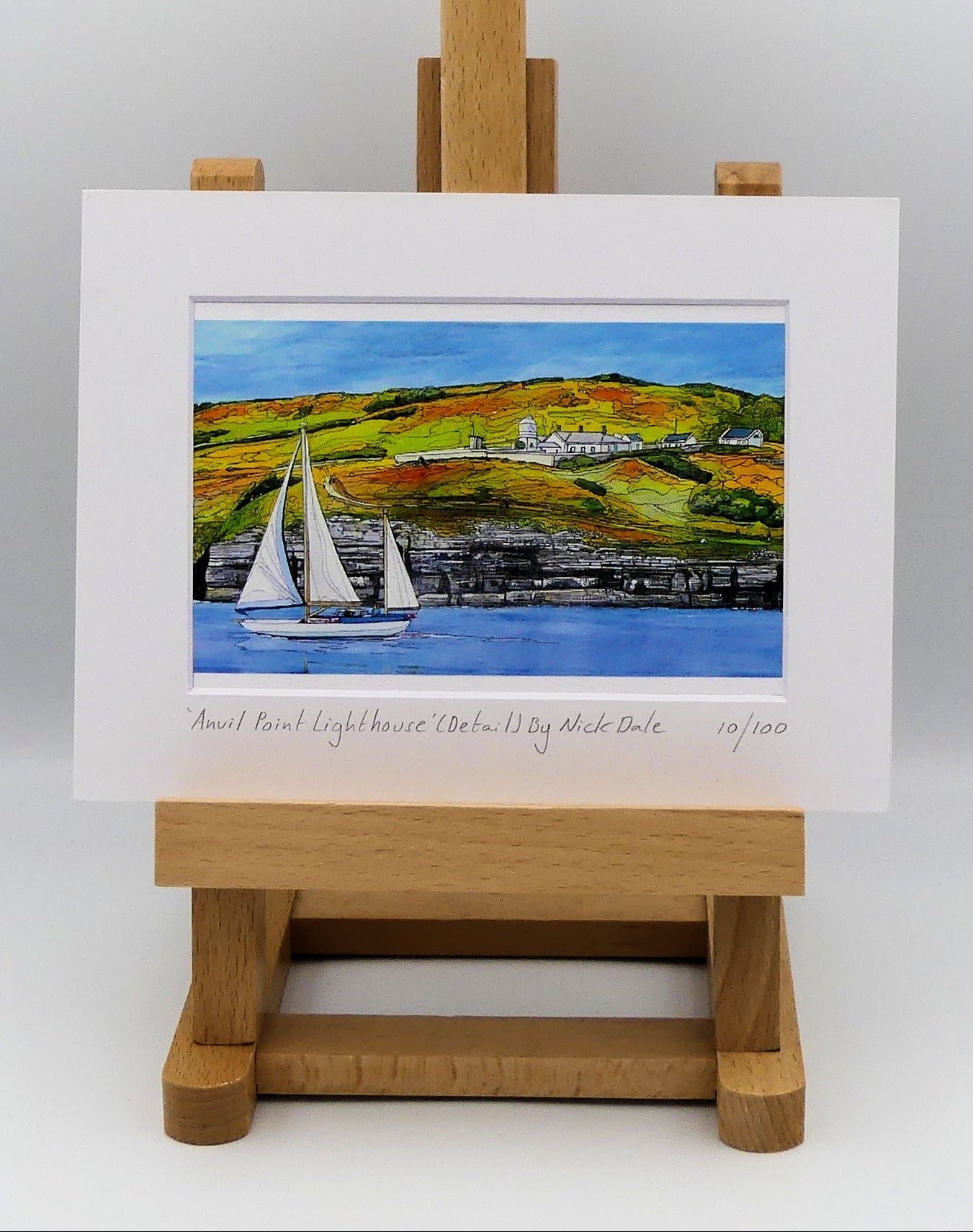 Image of a Small Art Print featuring a copy of the painting 'Anvil Point Lighthouse' by Nick Dale. The print depicts the part of the original painting showing the Anvil Point Lighthouse at Durlston Country Park, Swanage. Based on the view from the paddle-steamer Waverley. The print is situated on a small easel.