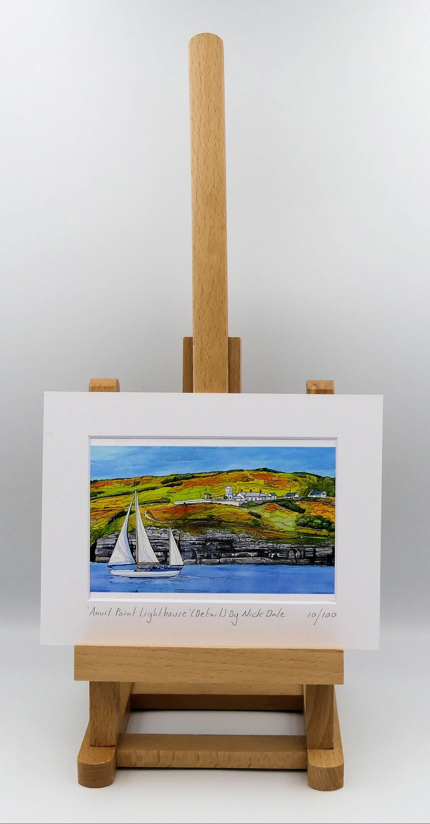 Image of a Small Art Print featuring a copy of the painting 'Anvil Point Lighthouse' by Nick Dale. The print depicts the part of the original painting showing the Anvil Point Lighthouse at Durlston Country Park, Swanage. Based on the view from the paddle-steamer Waverley. The print is situated on a small easel.