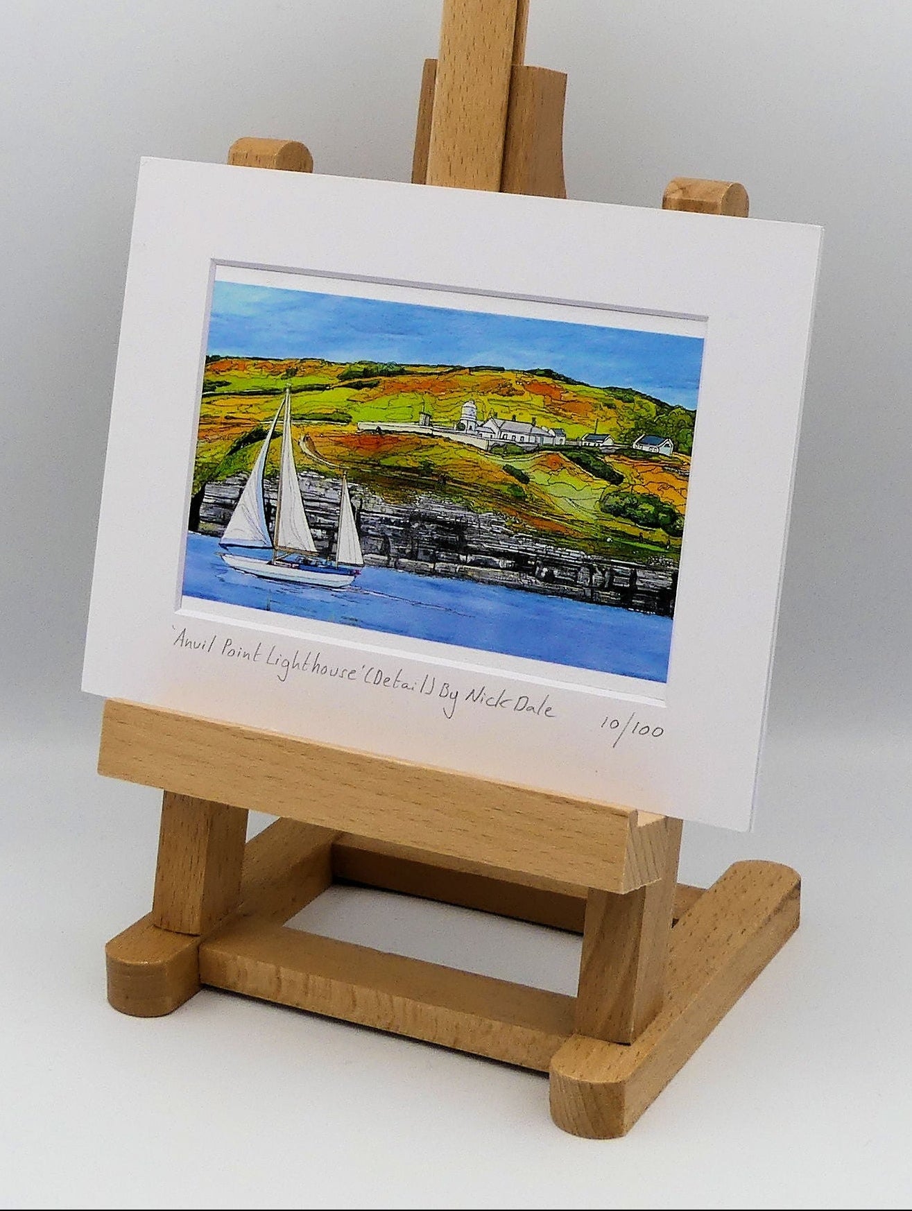 Image of a Small Art Print featuring a copy of the painting 'Anvil Point Lighthouse' by Nick Dale. The print depicts the part of the original painting showing the Anvil Point Lighthouse at Durlston Country Park, Swanage. Based on the view from the paddle-steamer Waverley. The print is situated on a small easel.