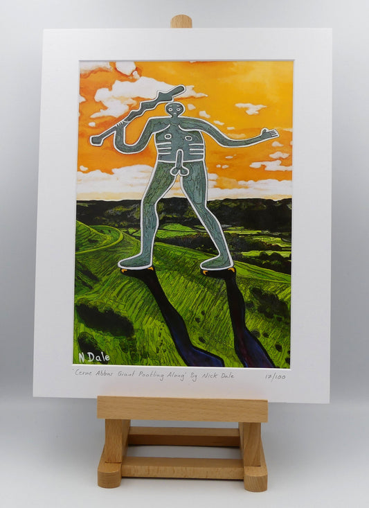 Image of a Medium Art Print featuring a copy of the painting 'Cerne Abbas Giant Pootling Along' by Nick Dale. The scene imagines the Cerne Abbas Giant chalk hill figure wandering across the Dorset landscape. The giant can be seen scaling Hod Hill in the Blackmore Vale. The print is situated on a small easel.