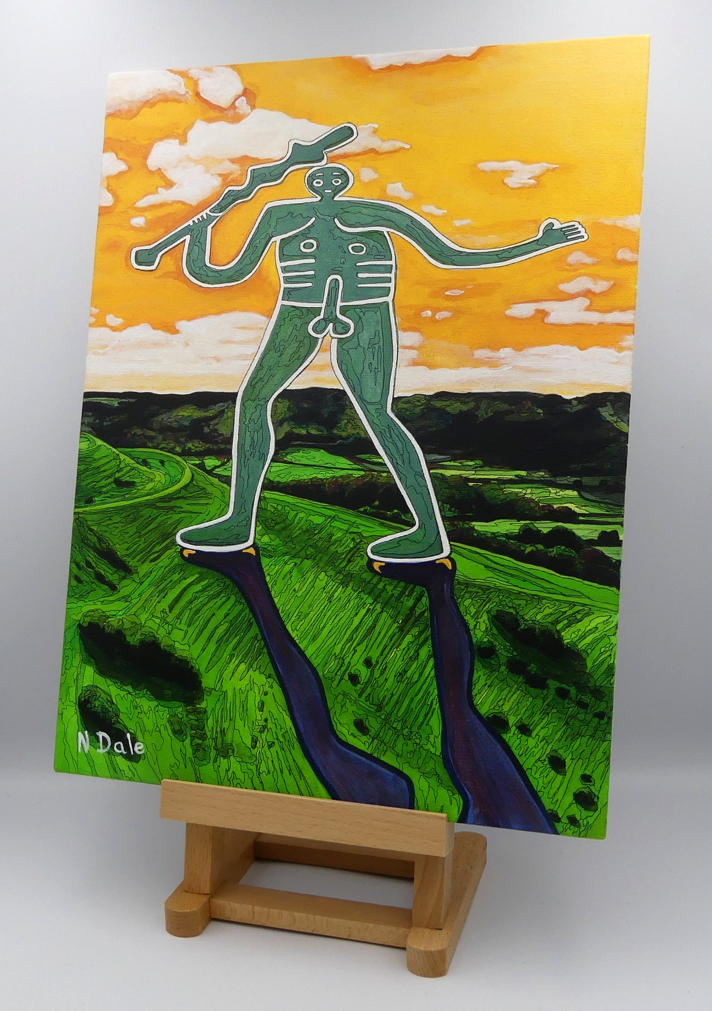 Image of the original painting 'Cerne Abbas Giant Pootling Along' by Nick Dale. The scene imagines the Cerne Abbas Giant chalk hill figure wandering across the Dorset landscape. The giant can be seen scaling Hod Hill in the Blackmore Vale.