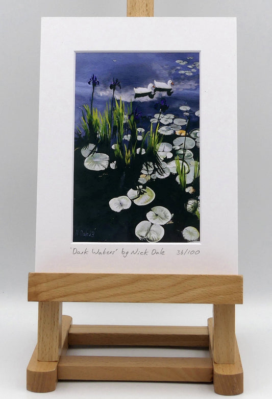 Image of a Small Art Print featuring a copy of the painting 'Dark Waters' by Nick Dale. The print depicts lily pads, irises and ducks on a pond at Knightshayes Court, Devon. The print is situated on a small easel.