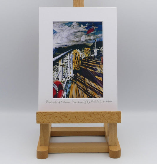 Image of Small Art Print featuring a copy of the painting 'Diminishing Returns From Lundy' by Nick Dale. The print depicts the stern of the ship MS Oldenburg as it returns to the mainland from Lundy Island, Devon. As the sun goes down it casts long shadows on the deck. whilst the flag flutters in the breeze. The Silhouette of the island can be seen diminishing into the background. The print is situated on a small easel.
