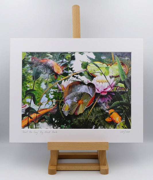Image of a Medium Art Print featuring a copy of the painting 'Don't Be Coy' by Nick Dale. The print depicts 3 koi carp along with water lilies and their flowers. The painting is based on fish and lilies observed at Bennetts Water Gardens in Weymouth, Dorset. The title is a play on the homophones 'Coy' and 'Koi'. The print is situated on a small easel.