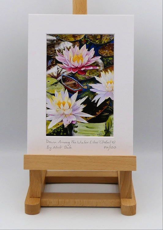 Image of a Small Art Print featuring a copy of a detail from the painting 'Down Among The Water Lilies' by Nick Dale. The print depicts the part of the original painting showing the rowing boat and a close-up view of the water lilies at Bennetts Water Gardens in Weymouth, with the twist of the boat being shrunk down to lilliputian dimensions.  The print is situated on a small easel.