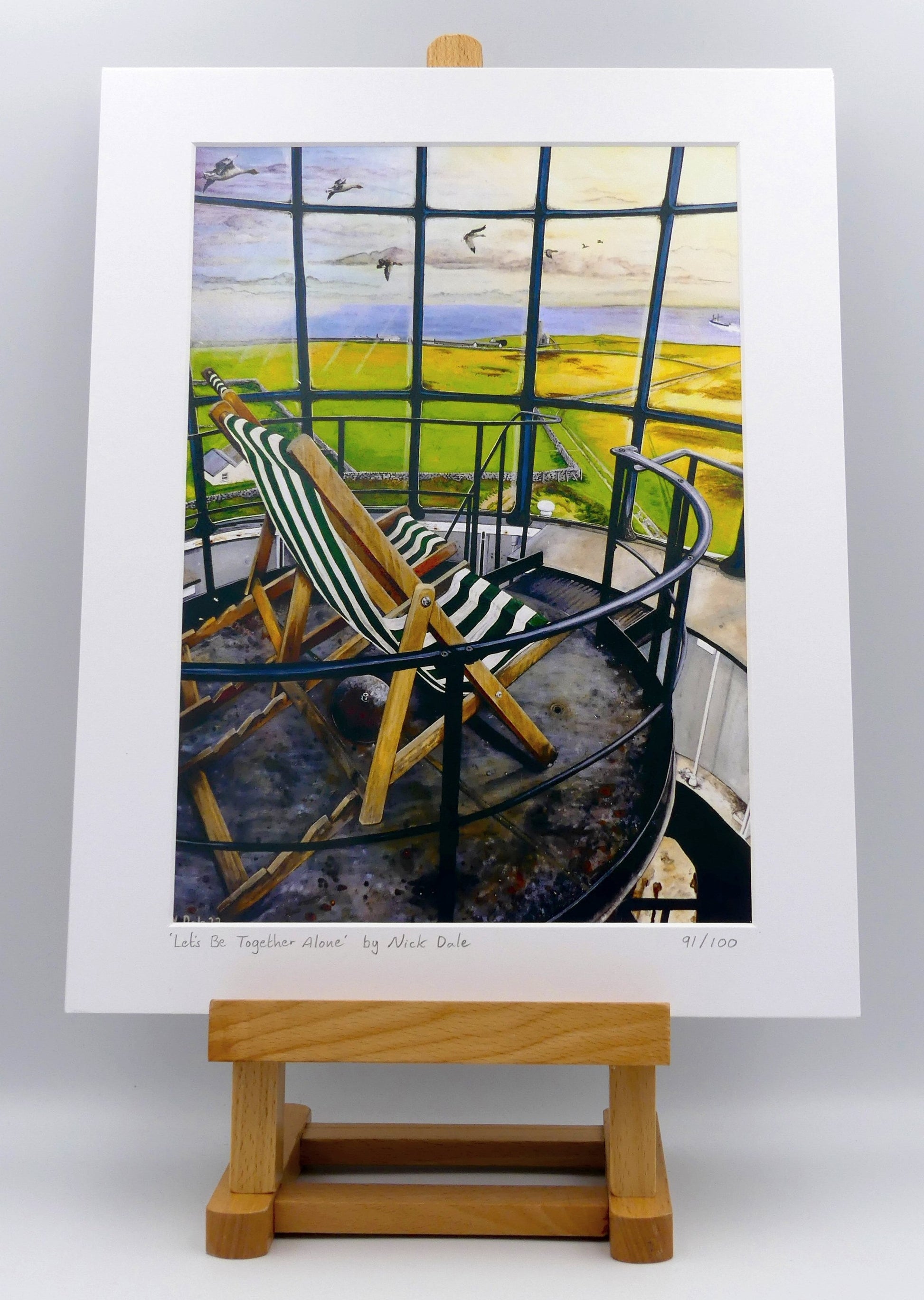 Image of a Medium Art Print featuring a copy of the painting 'Let's Be Together Alone' by Nick Dale. The print depicts the view from the lantern room of the Old Light lighthouse on Beacon Hill, on the island of Lundy, Devon. The print is situated on a small easel.