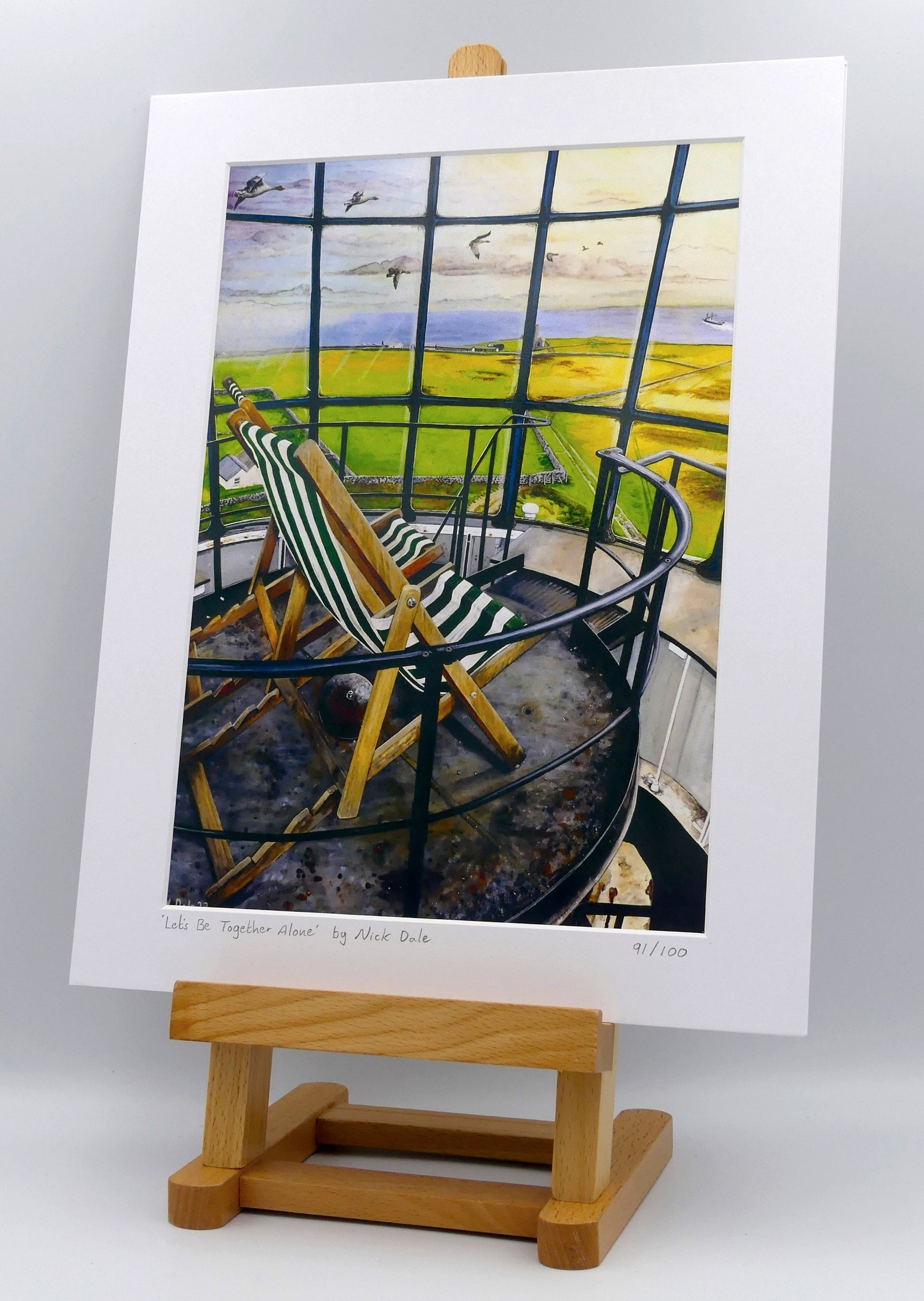 Image of a Medium Art Print featuring a copy of the painting 'Let's Be Together Alone' by Nick Dale. The print depicts the view from the lantern room of the Old Light lighthouse on Beacon Hill, on the island of Lundy, Devon. The print is situated on a small easel.
