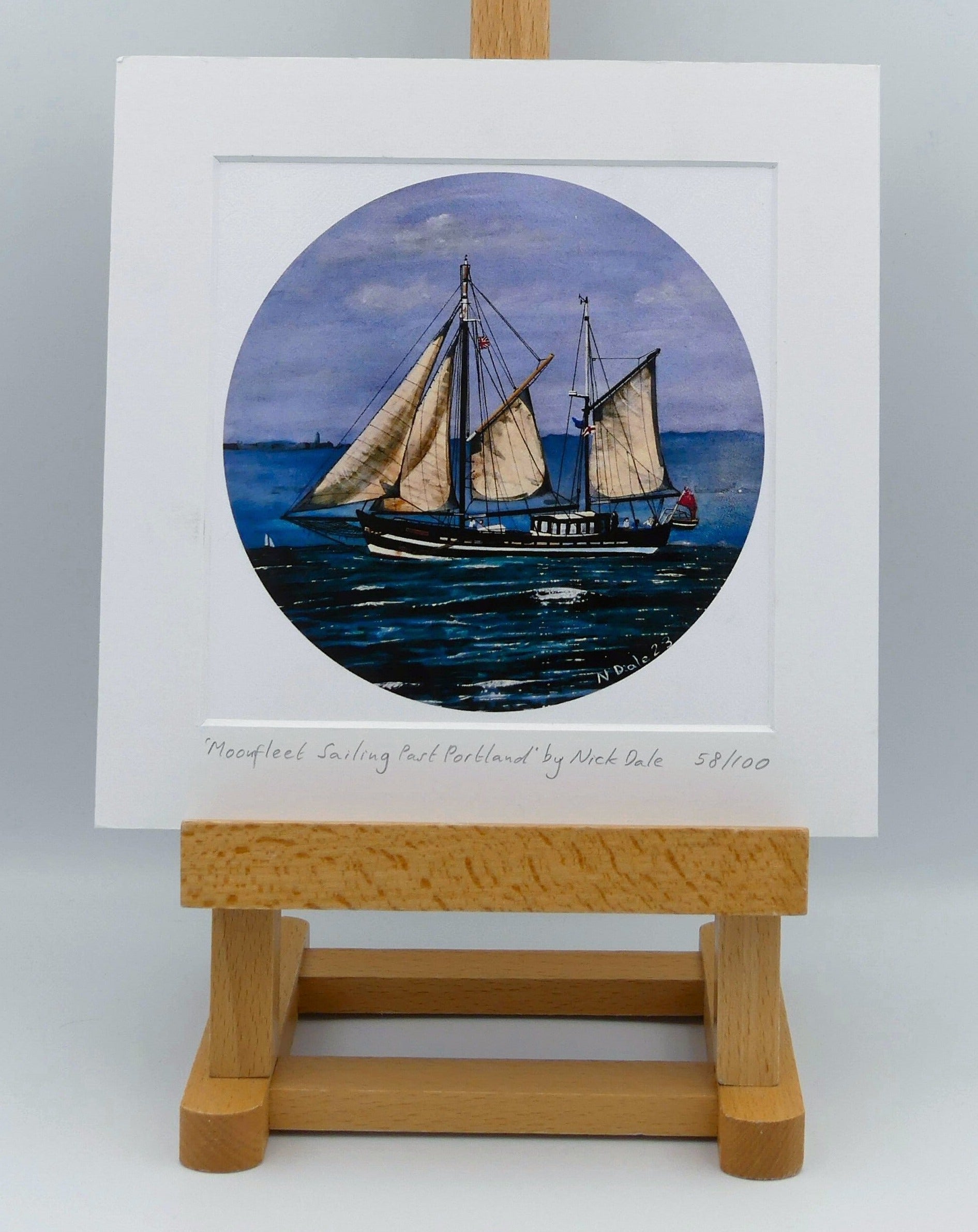 Image of Square Medium Art Print featuring a copy of the painting 'Moonfleet Sailing Past Portland' by Nick Dale. The print depicts the tall ship Moonfleet sailing past the western coast of Portland, Dorset. As observed from Ringstead Beach. The print is situated on a small easel.