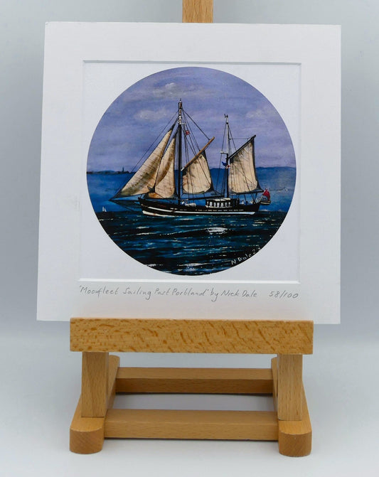 Image of Square Medium Art Print featuring a copy of the painting 'Moonfleet Sailing Past Portland' by Nick Dale. The print depicts the tall ship Moonfleet sailing past the western coast of Portland, Dorset. As observed from Ringstead Beach. The print is situated on a small easel.