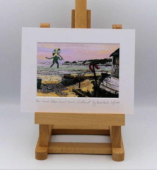 Image of a Small Art Print featuring a copy of the painting 'Mrs Cerne Abbas Giant Visits Studland' by Nick Dale. The print imagines the Cerne Abbas Giant's wife visiting the seaside at Studland Beach; with Old Harry Rocks and the Isle of Wight in the distance.  The print is situated on a small easel.