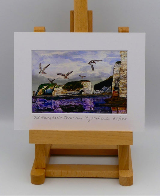 Image of a Small Art Print featuring a copy of the painting 'Old Harry Rocks Turns Over' by Nick Dale. The print depicts the view on a walk in March 2025 when the tide was completely out so I could walk to Old Harry Rocks. I never realised that that was ever possible. I had to add in the water when I painted it afterwards as it was completely missing. Turns also added to taste.  The print is situated on a small easel.