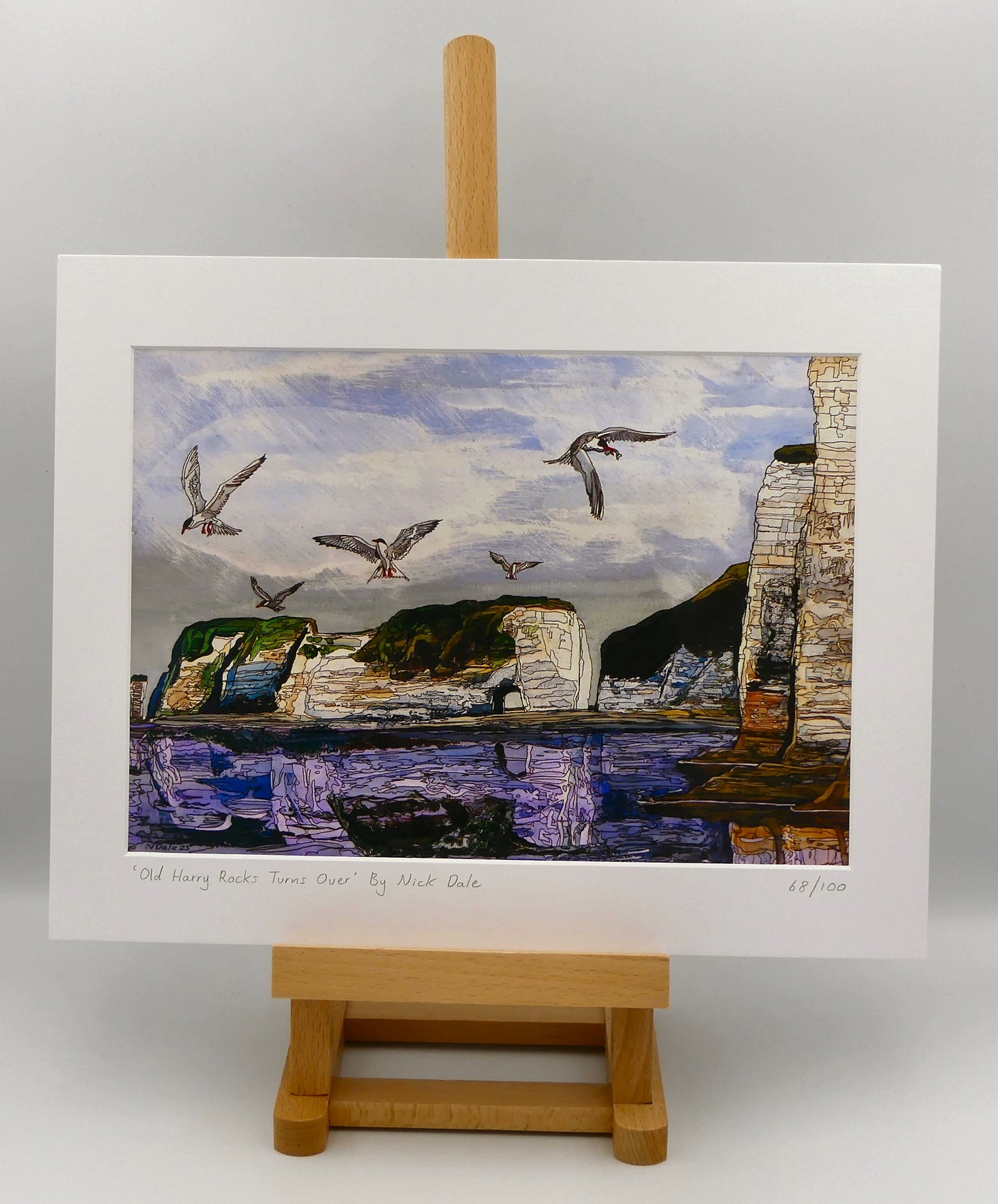 Image of a Medium Art Print featuring a copy of the painting 'Old Harry Rocks Turns Over' by Nick Dale. The print depicts the view on a walk in March 2025 when the tide was completely out so I could walk to Old Harry Rocks. I never realised that that was ever possible. I had to add in the water when I painted it afterwards as it was completely missing. Turns also added to taste. The print is situated on a small easel.