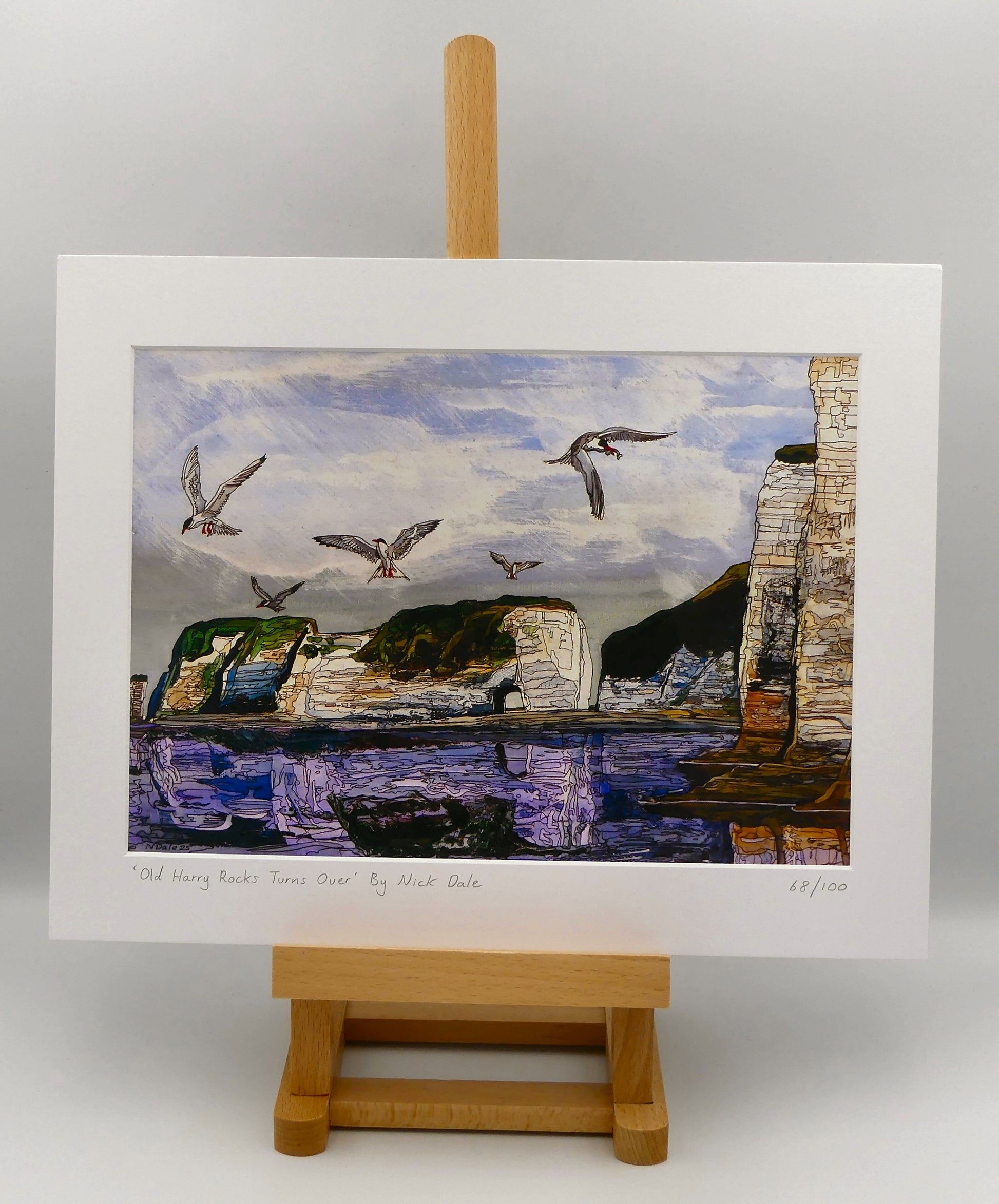 Image of a Medium Art Print featuring a copy of the painting 'Old Harry Rocks Turns Over' by Nick Dale. The print depicts the view on a walk in March 2025 when the tide was completely out so I could walk to Old Harry Rocks. I never realised that that was ever possible. I had to add in the water when I painted it afterwards as it was completely missing. Turns also added to taste. The print is situated on a small easel.
