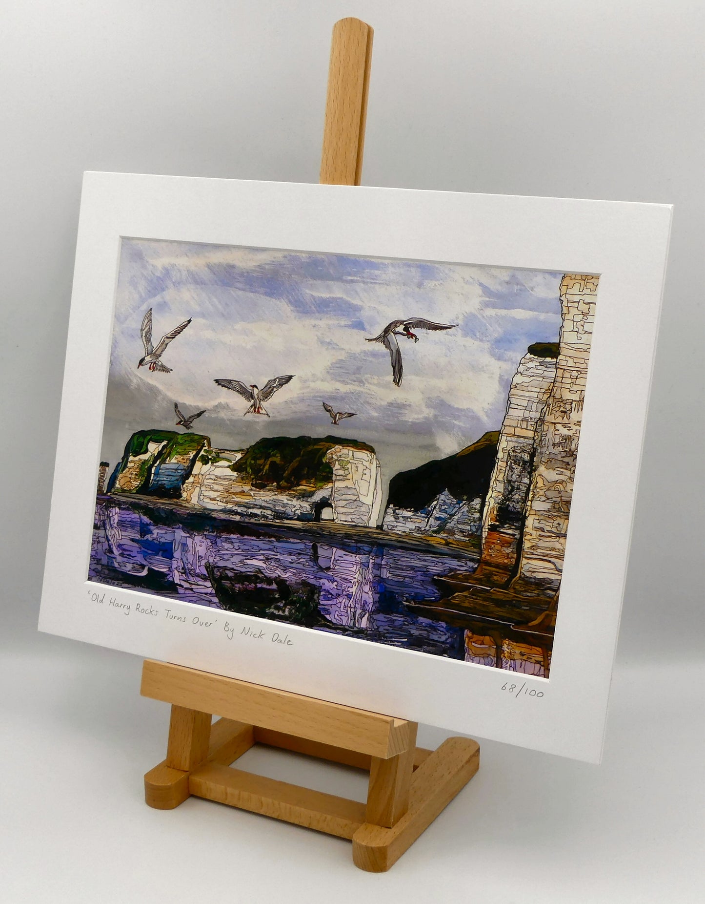 Image of a Medium Art Print featuring a copy of the painting 'Old Harry Rocks Turns Over' by Nick Dale. The print depicts the view on a walk in March 2025 when the tide was completely out so I could walk to Old Harry Rocks. I never realised that that was ever possible. I had to add in the water when I painted it afterwards as it was completely missing. Turns also added to taste. The print is situated on a small easel.