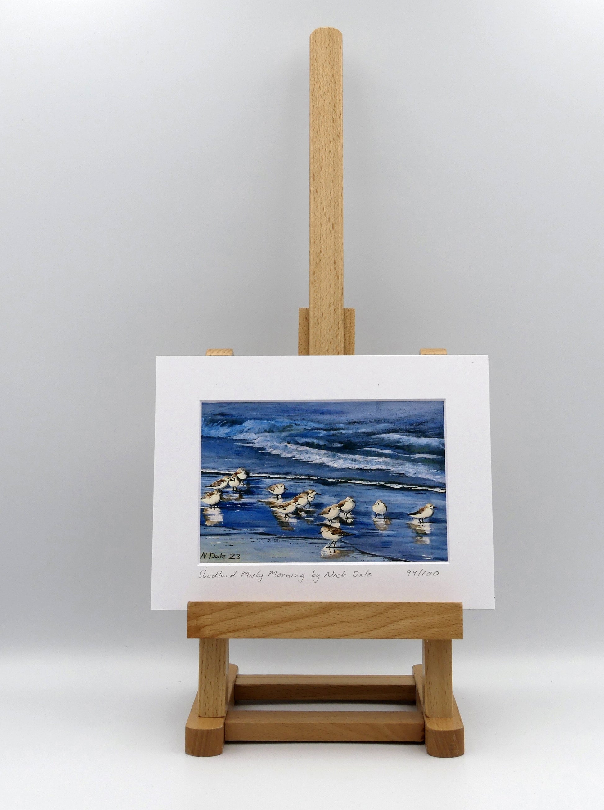 Image of a Small Art Print featuring a copy of the painting 'Studland Misty Morning' by Nick Dale. The print depicts Dunlins on Studland Beach (Dorset) on a crisp and misty morning. The print is situated on a small easel.
