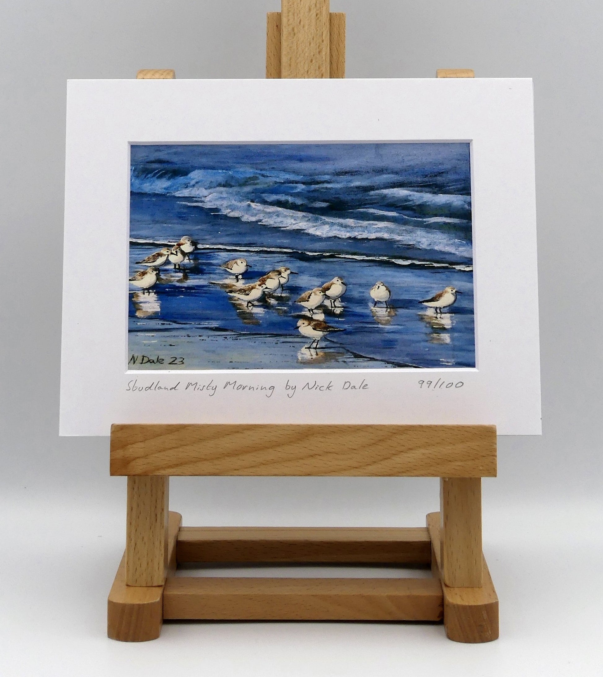 Image of a Small Art Print featuring a copy of the painting 'Studland Misty Morning' by Nick Dale. The print depicts Dunlins on Studland Beach (Dorset) on a crisp and misty morning. The print is situated on a small easel.