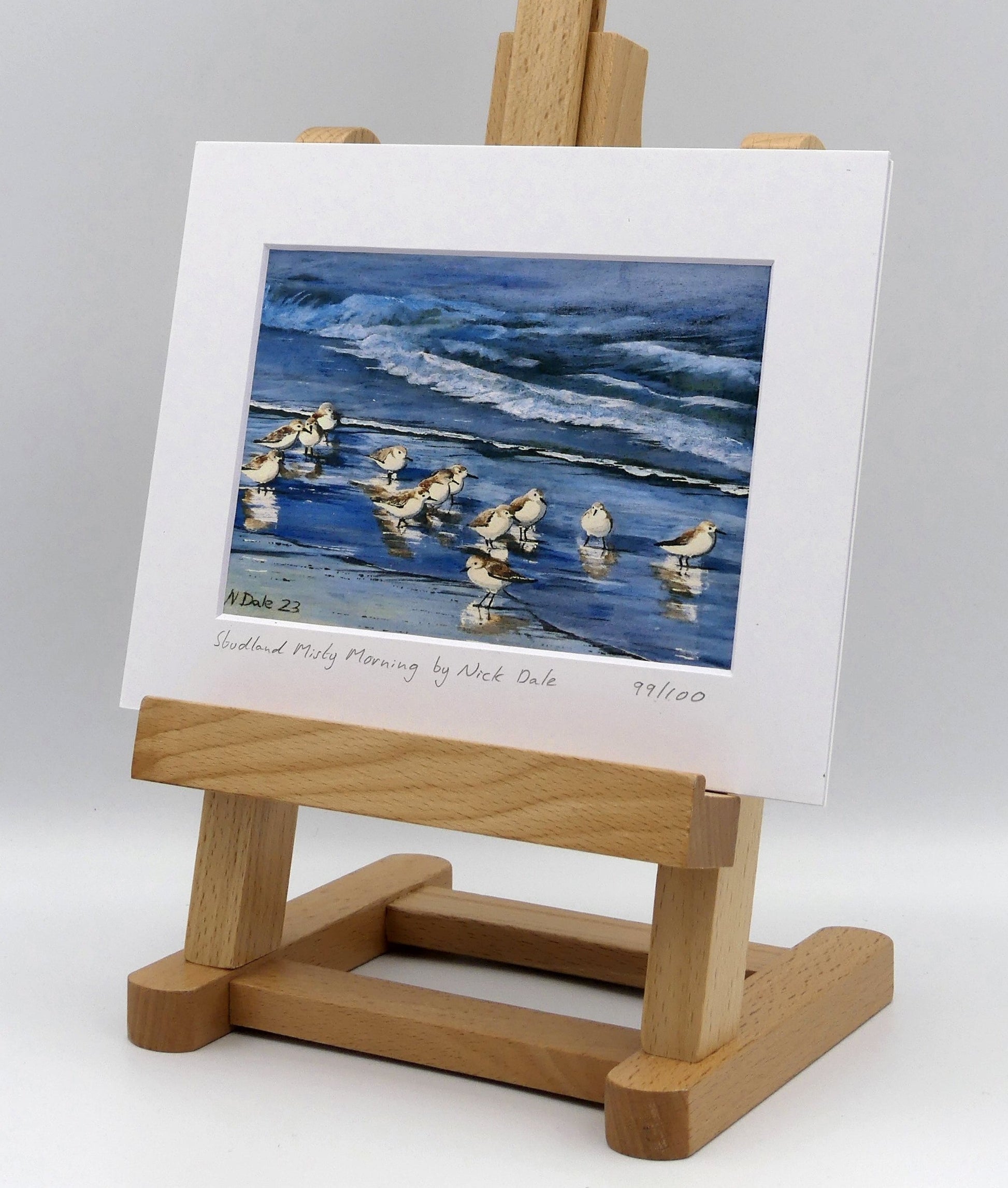 Image of a Small Art Print featuring a copy of the painting 'Studland Misty Morning' by Nick Dale. The print depicts Dunlins on Studland Beach (Dorset) on a crisp and misty morning. The print is situated on a small easel.