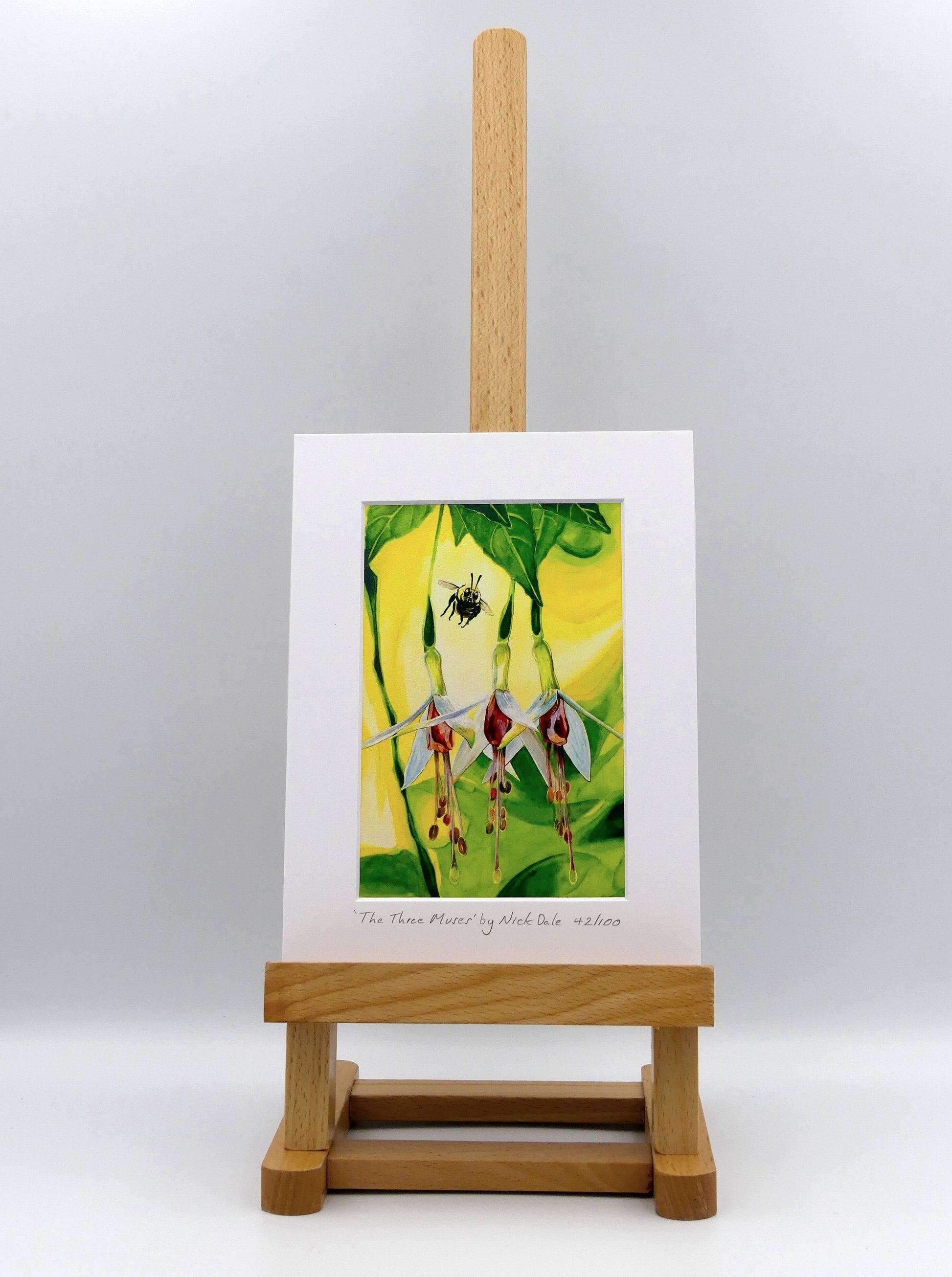 Image of a Small Art Print featuring a copy of the painting 'The Three Muses' by Nick Dale. The print depicts a close-up view of a bee approaching its prize. But which will it choose? The print is situated on a small easel.