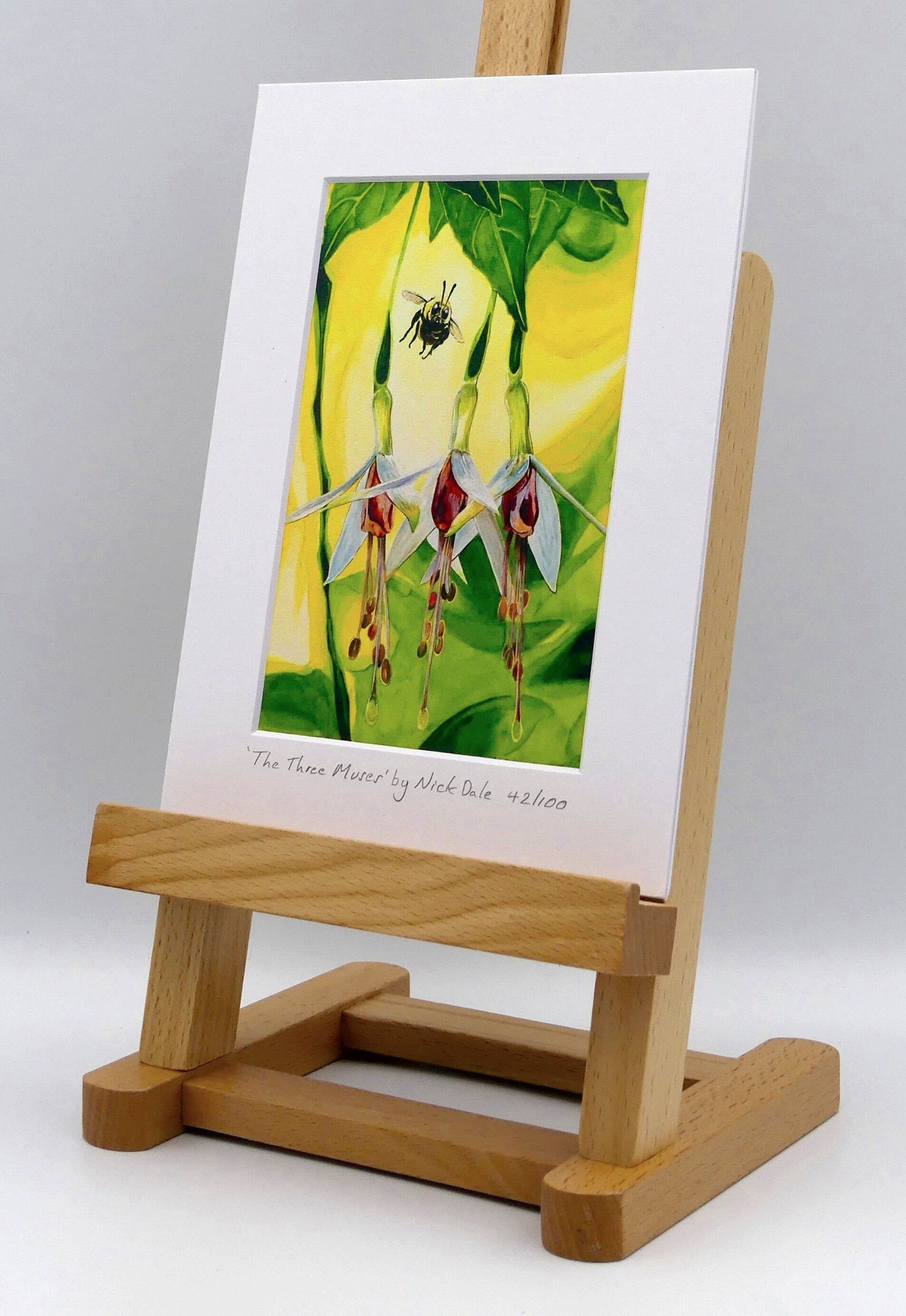Image of a Small Art Print featuring a copy of the painting 'The Three Muses' by Nick Dale. The print depicts a close-up view of a bee approaching its prize. But which will it choose? The print is situated on a small easel.