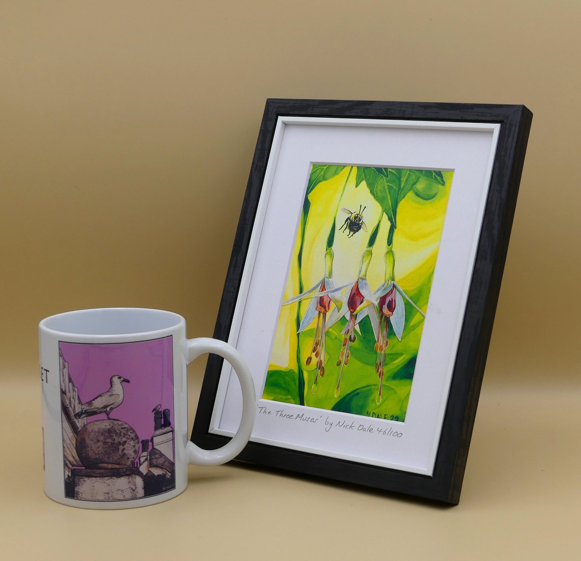 Image of a Small Art Print featuring a copy of the painting 'The Three Muses' by Nick Dale. The print depicts a close-up view of a bee approaching its prize. But which will it choose? The print is situated in a black frame next to a mug.