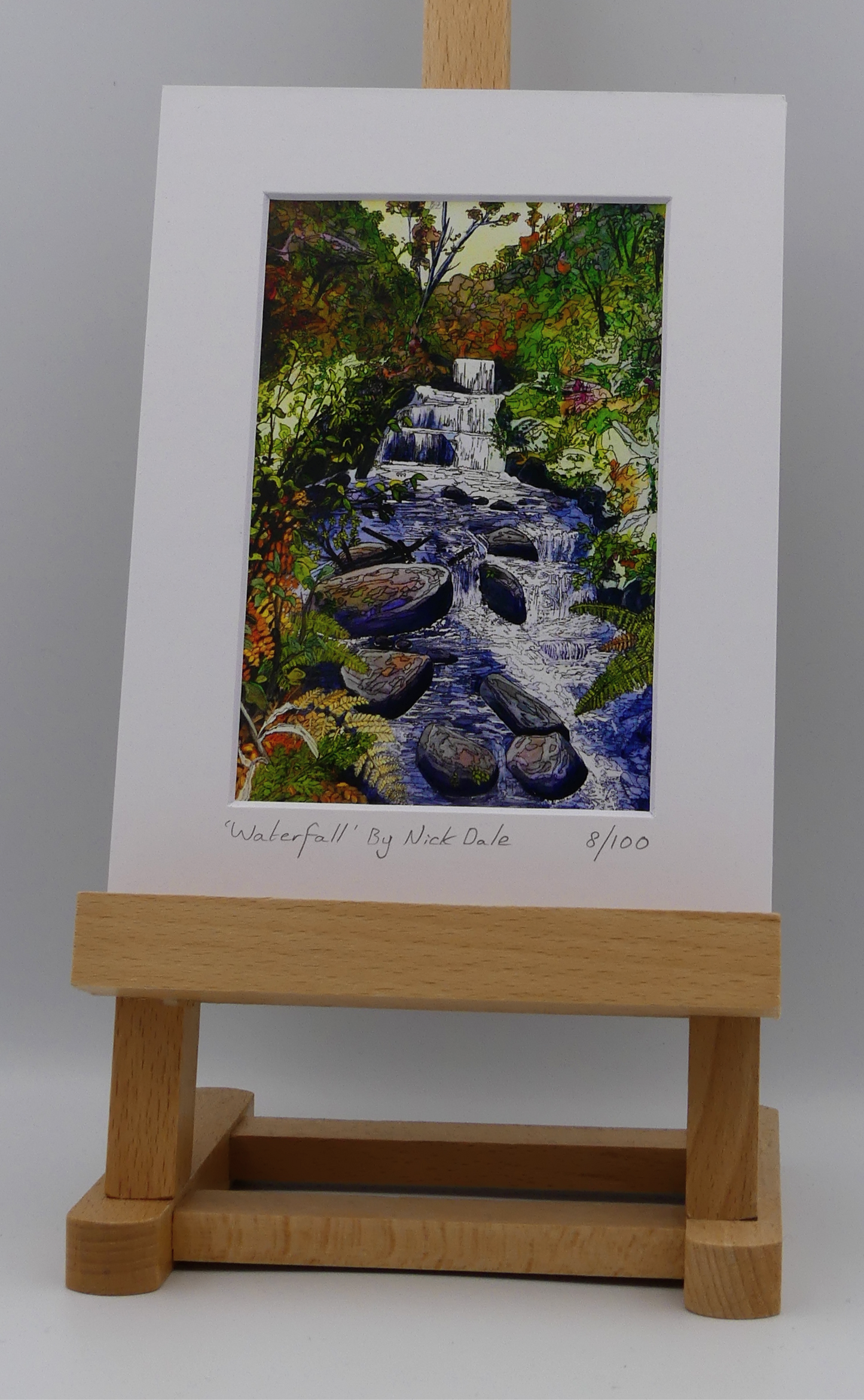 Image of a Small Art Print featuring a copy of the painting 'Waterfall' by Nick Dale. The scene depicts the Hoar Oak Waterfall on the Hoar Oak Water moorland tributary of the East Lyn River at the famous National Trust site of Watersmeet House, Lynmouth, Devon.  The print is situated on a small easel.