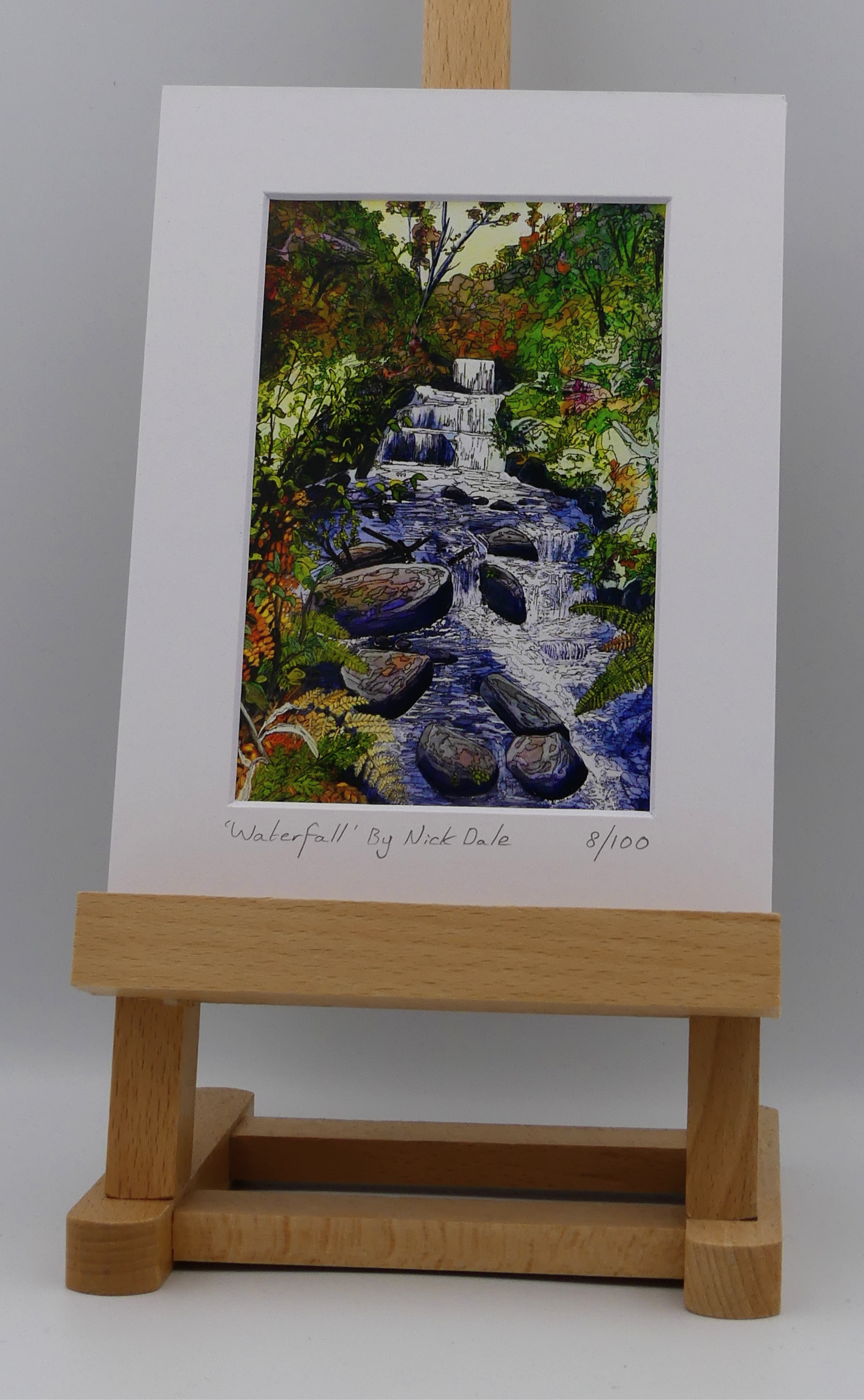 Image of a Small Art Print featuring a copy of the painting 'Waterfall' by Nick Dale. The scene depicts the Hoar Oak Waterfall on the Hoar Oak Water moorland tributary of the East Lyn River at the famous National Trust site of Watersmeet House, Lynmouth, Devon.  The print is situated on a small easel.