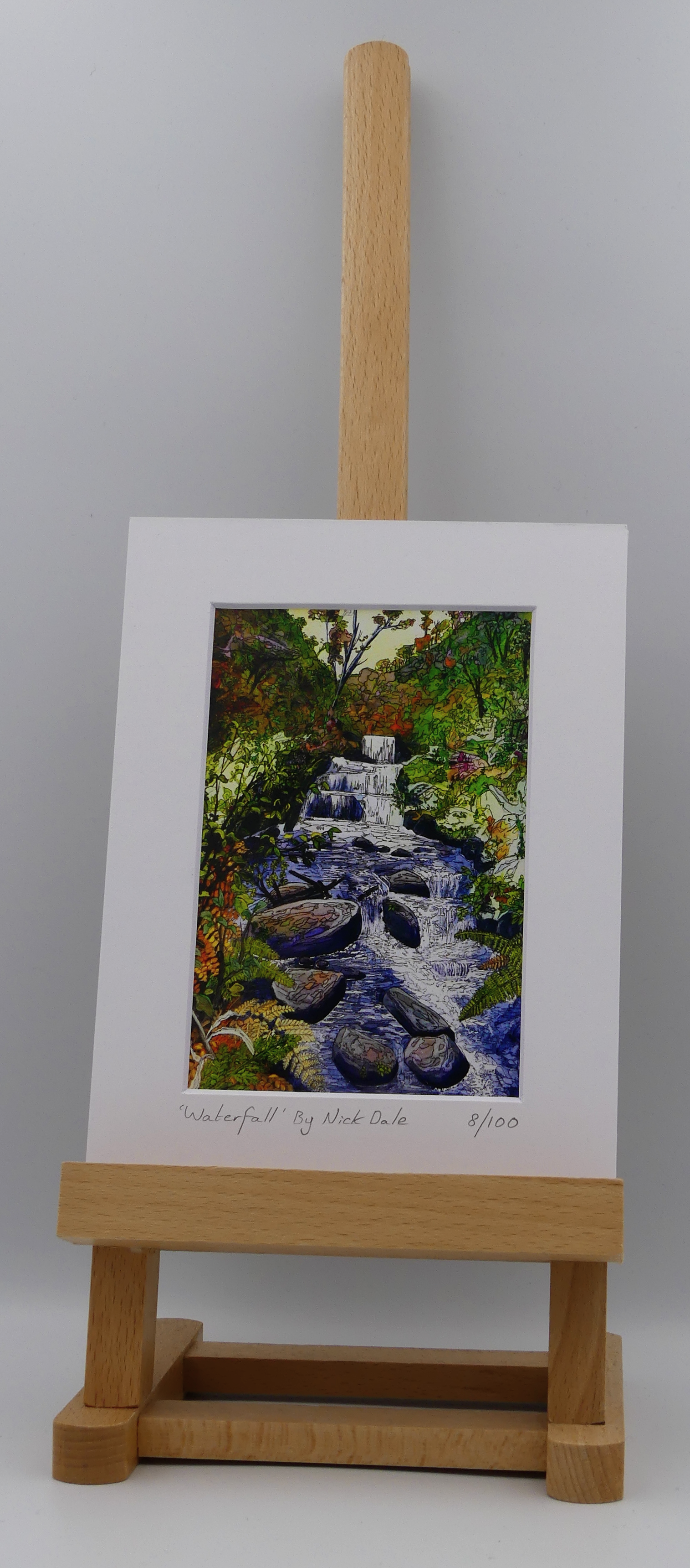 Image of a Small Art Print featuring a copy of the painting 'Waterfall' by Nick Dale. The scene depicts the Hoar Oak Waterfall on the Hoar Oak Water moorland tributary of the East Lyn River at the famous National Trust site of Watersmeet House, Lynmouth, Devon. The print is situated on a small easel.