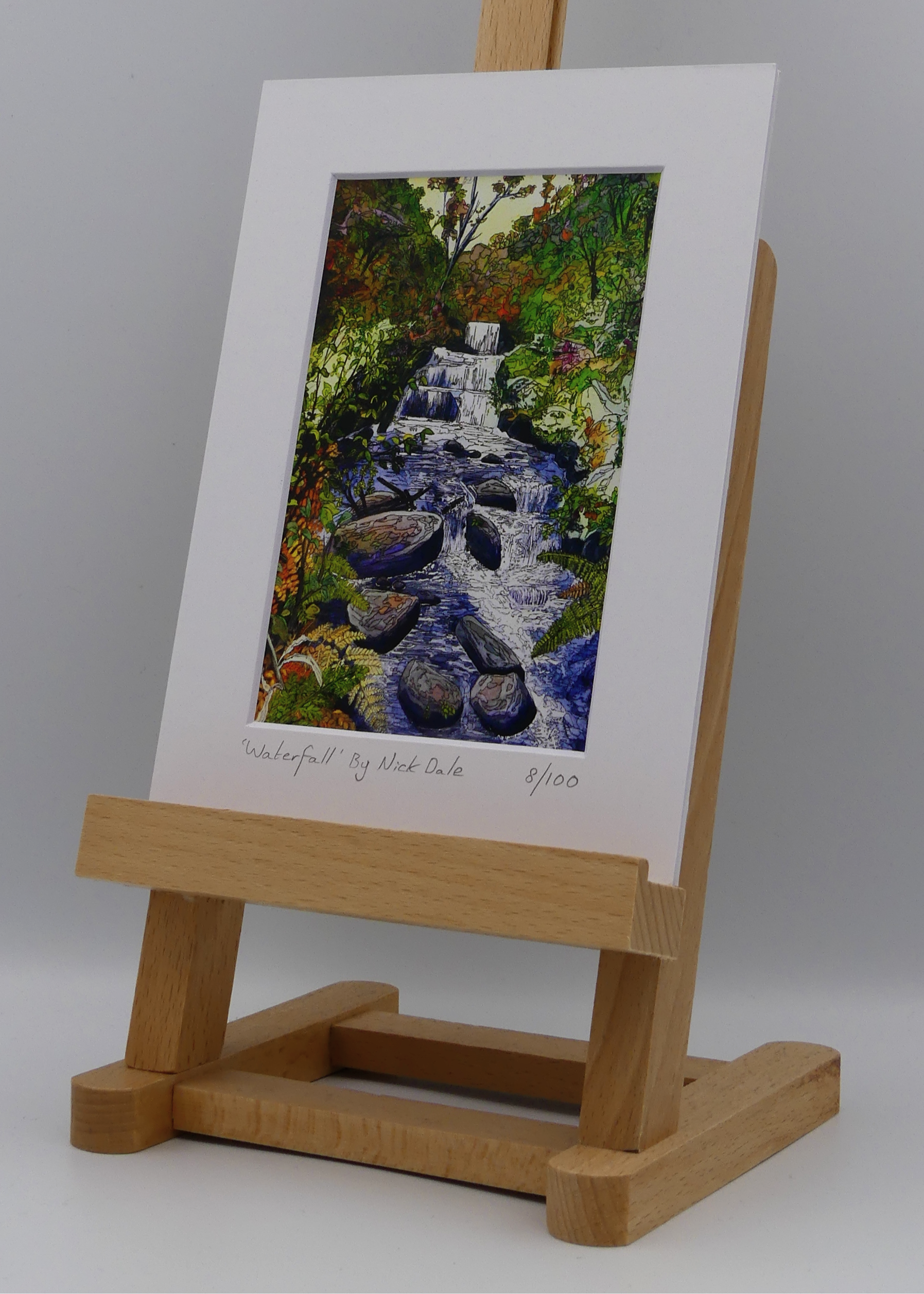 Image of a Small Art Print featuring a copy of the painting 'Waterfall' by Nick Dale. The scene depicts the Hoar Oak Waterfall on the Hoar Oak Water moorland tributary of the East Lyn River at the famous National Trust site of Watersmeet House, Lynmouth, Devon. The print is situated on a small easel.